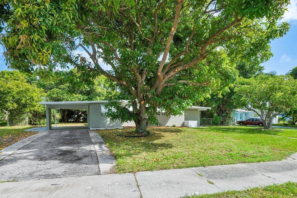 Photo of 715 W Jasmine Drive, Lake Park, FL 33403 (MLS # R11008064)