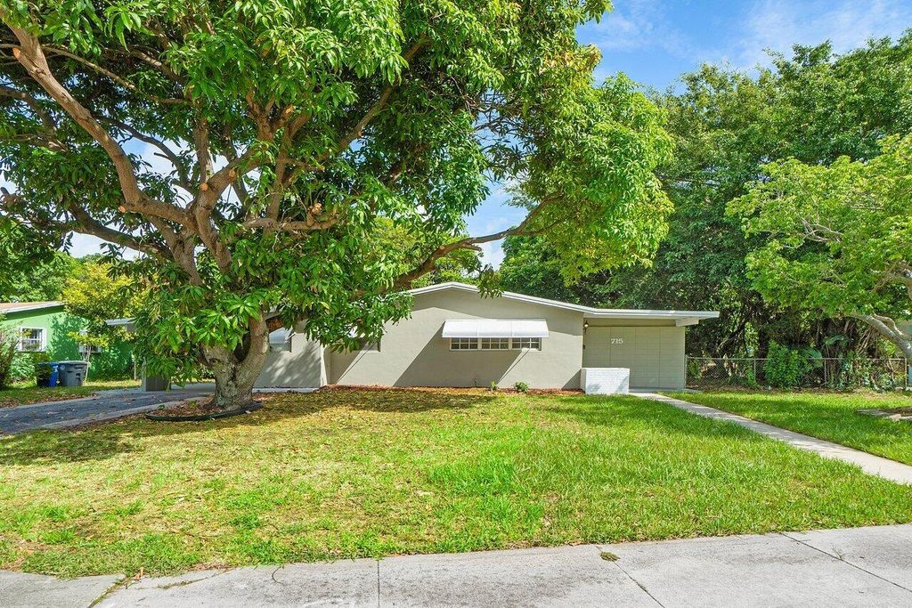 Photo of 715 W Jasmine Drive, Lake Park, FL 33403 (MLS # R11008064)