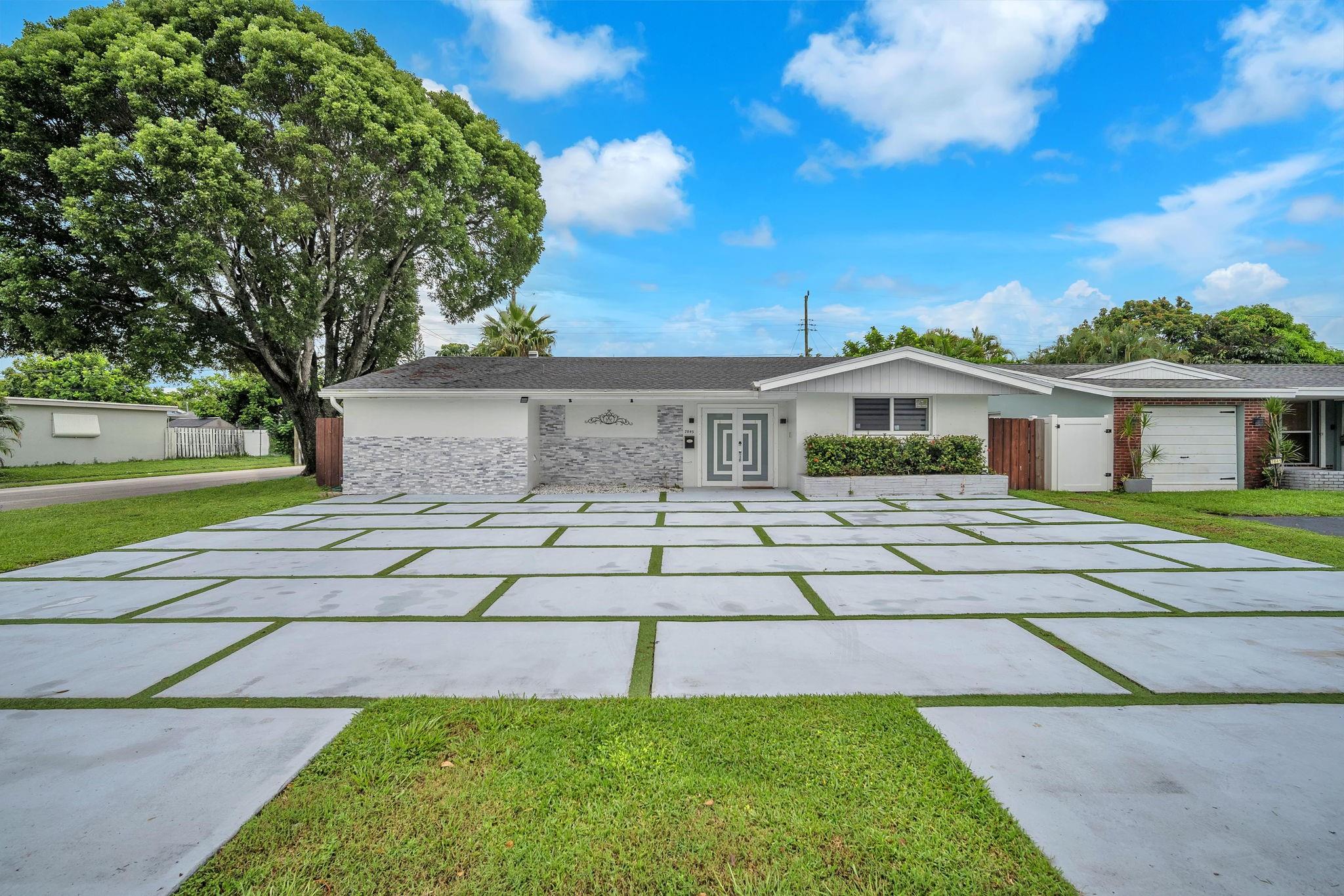 Stunning 3-bedroom, 2-bathroom single-family pool home with jacuzzi on a corner lot boasting unparalleled curb appeal with its modern concrete driveway with AstroTurf, elegant stone exterior, luxury double impact doors & charming enclosed lanai entry. Modern tile throughout, newer roof, AC, impact windows, SS appliances, sleek finishes, luxury bathrooms adorned with contemporary tile designs, glass door, LED mirror, and rain shower for a spa-like experience. Gas stove, zebra shades, indoor laundry with built-ins. Private fenced backyard oasis with pool and jacuzzi. Bonus room with a unique opportunity, can be used as an in-law suite or extra bedroom has a separate entrance, kitchenette, full refrigerator & full modern bathroom. Income producing rental - $1,200 a month.