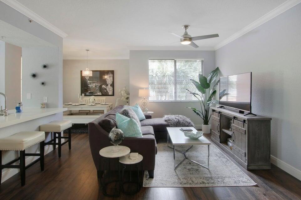 This turnkey, well maintained beautiful fully renovated 2-bed/2-bath condominium in Legacy Place. This presents an exceptional opportunity. 1,309 sq ft second-floor corner unit features dark wood plank flooring, quartz countertops, stainless steel appliances, crown molding, and upgraded A/C. Two reserved parking spaces. Enjoy resort-style amenities--pool, tennis, clubhouse, fitness center--just minutes from shopping, dining, and beaches. Move-in ready and perfectly located in Palm Beach Gardens. You can rent right away, 2x's per yearInformation is deemed reliable, but not guaranteed. All measurements, room sizes, and property details are approximate. Buyers should verify all information independently, including HOA fees, rules, and restrictions.
