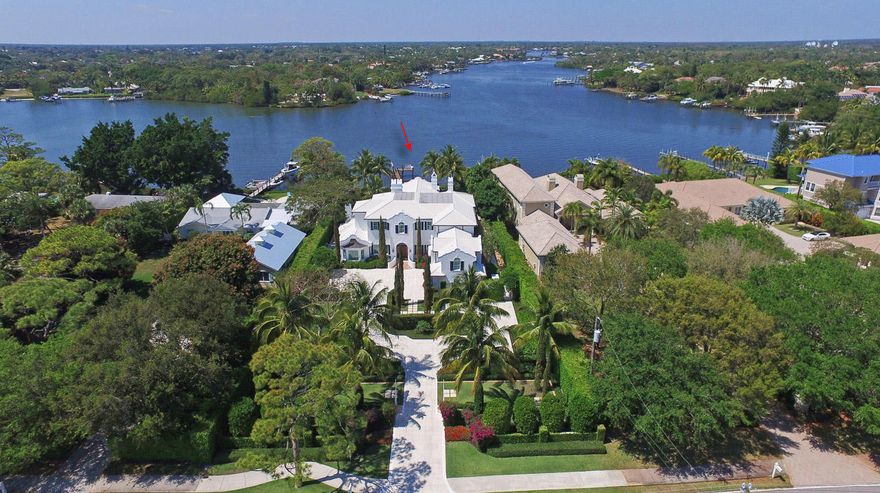 This stunning Dutch Colonial Riverfront Estate is rich and well appointed! 6  en-suite bedrooms with one designed with kitchen & family room,  splendid living room, a luxurious gourmet kitchen, grand formal dining room with dramatic millwork, a room size vault for valuables are just a few of the features of this magnificent home. The quality of construction is impeccable! The white Thassos marble floors and the white oak ''rift cut'' insets are pure elegance. Wide water views are the back drop to a perfect location for fun on the water, relaxing by the pool or just gazing a the tranquil rippling water.  Lavish landscaping frames the true elegance of this Palm Beach inspired home.