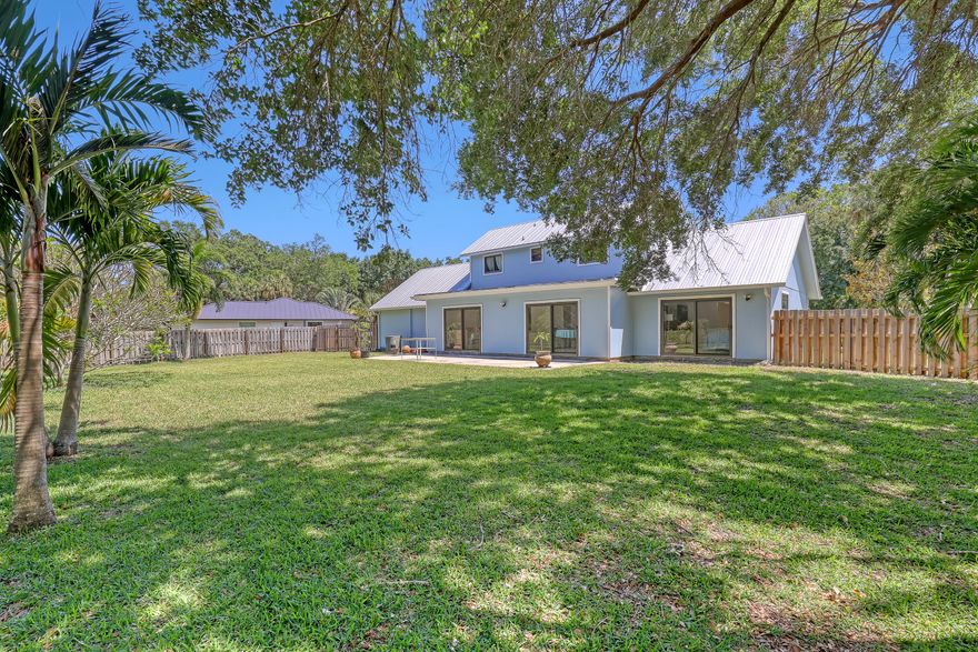 Don't miss this incredible opportunity in one of the area's most charming, best-kept secret neighborhoods located in beautiful Palm Beach Gardens. Situated on an oversized lot, with lush private foliage in your backyard this home offers endless potential to create something truly special! Featuring 3 bedrooms and 2.5 baths, with a primary suite on the main floor and two additional bedrooms + bathroom upstairs, the layout is both functional and inviting. Vaulted ceilings and a wood burning fireplace adds true character to the living space. Recent upgrades include a metal roof and brand new impact windows throughout. The expansive lot offers ample room to create an outdoor living space for enjoying and entertaining.  Plenty of room to store your boat and RV as well. With an unbeatable location and a rare opportunity this one is something special.