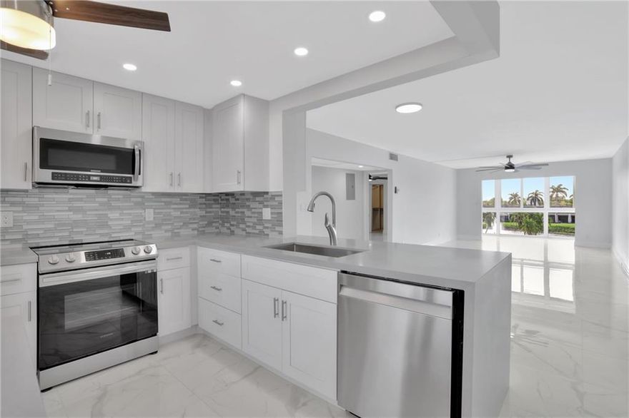 THE MOST SPECTACULAR GOLF, LAKE AND CLUBHOUSE VIEWS IN ALL OF WYNMOOR! THIS COMPLETELY REMODELED 2BR/2BATH CONDO FEATURES NEW HURRICANE IMPACT WINDOWS, PORCELAIN FLOORS, DESIGNER KITCHEN W SHAKER CABINETS, QUARTZ WATERFALL COUNTER TOPS W OVERHANG FOR BREAKFAST/BUFFET AREA, HIGH END ST/ST APPLIANCES, DESIGNER BATHROOMS, WASHER-DRYER IN UNIT,  THIS 24/7 PATROLLED GATED COMMUNITY FEATURES: NEW SWIMMING POOL W BARBEQUE STATION, 18 HOLE GOLF COURSE, CLUB HOUSE, RESTAURANT, TENNIS/PICKELBALL, 962 SEAT THEATER FOR MOVIES AND SHOWS, FITNESS CENTER, ZUMBA AND WATER AEROBIC CLASSES, BILLIARDS CENTER, 18 HEATED POOLS, RESISTANCE WALKING POOL, HOT SPA, SHUTTLE BUS SERVICE, AND OVER 80 CLUBS TO MEET NEW FRIENDS AND ENJOY LIFE IN THE TROPICAL PARADISE OF WYNMOOR! ALL OFFERS WILL BE SERIOUSLY CONSIDERED.