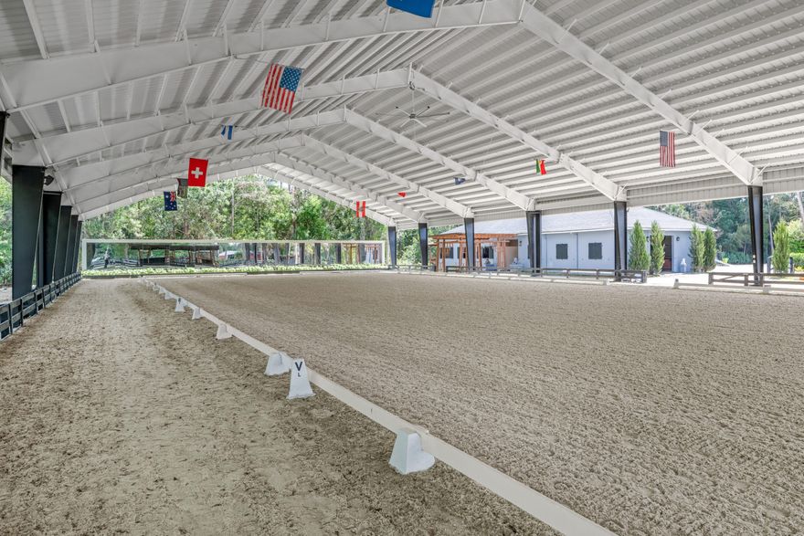 Available for annual or seasonal rental- 17 stalls, 5bed/3bath home, grooms apartment and rv hookups- Owner is willing to lease all together or separately. Set beneath a canopy of mature oak trees and just 13 minutes from Wellington International, this exceptional equestrian estate features two CBS barns totaling 17 stalls, thoughtfully designed with custom stall fronts, elegant chandeliers, and quality finishes throughout. Newly constructed 2022 covered arena (120 x 190) with GGT footing, Ebb & Flow watering system, custom mirrors, fans and spacious viewing area delivering an elevated experience. Supporting the facility are eight irrigated paddocks, a round pen, tack room with lounge, feed rooms, full bathroom with wood tile accents, laundry and exceptional groom's quarters. The grounds also feature a pond with a dock and seating area, a fenced dog park, and a gazebo ideal for entertaining or quiet evenings outdoors. Surrounded by lush landscaping and natural shade, the property offers both privacy and functionality, with a layout ideal for a boutique training operation or private equestrian retreat—just moments from the heart of Wellington's world-class competition venues. Also available is a completely remodeled 5-bedroom, 3-bath residence seamlessly blends comfort and style. The chef's kitchen is centered around a dramatic 15-foot island with quartzite countertops, stainless steel appliances, and a wine chiller, ideal for both everyday living and entertaining. The primary suite offers a private retreat with a wood-burning fireplace, an expansive custom walk-in closet with seating area, and a beautifully appointed bath featuring dual vanities, a soaking tub, and a walk-in shower with dual shower heads. A guest ensuite bedroom provides additional comfort and flexibility for visitors. Outdoor living is equally impressive, with a private, fenced pool terrace finished in travertine with custom turf inlay, creating a clean, architectural aesthetic with a relaxed, resort-style feel. Annual price for entire property- $36,667