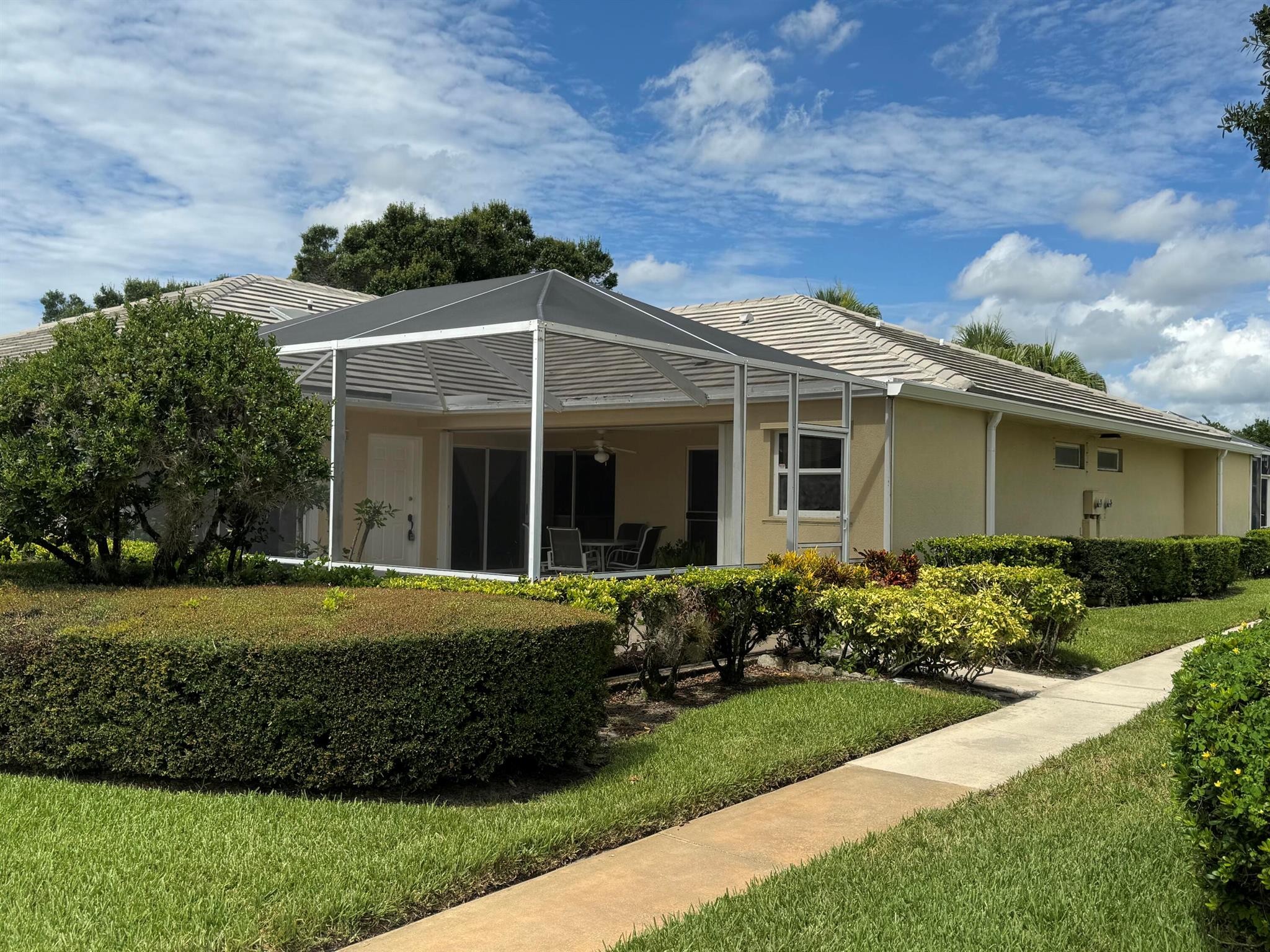 Florida Living at Its Best in St. Lucie West! Experience the best of Florida living in this freshly painted DiVosta villa featuring a large, fully screened patio--perfect for outdoor dining, entertaining, or simply relaxing year-round. This light-filled home offers an open floorplan with tile through-out, vaulted ceilings, skylights, and split bedrooms--each with direct access to the outdoor living space. Accordion hurricane shutters and NO polybutylene pipes are welcome news when getting insurance!HOA fee includes lawn care, basic cable TV, exterior & roof maintenance, building insurance, on-site management, & more. Amenities include a pool, tennis courts, pickleball, sidewalks, and streetlights. Location is convenient to I-95 & the St. Lucie West shopping, dining, and entertainment.
