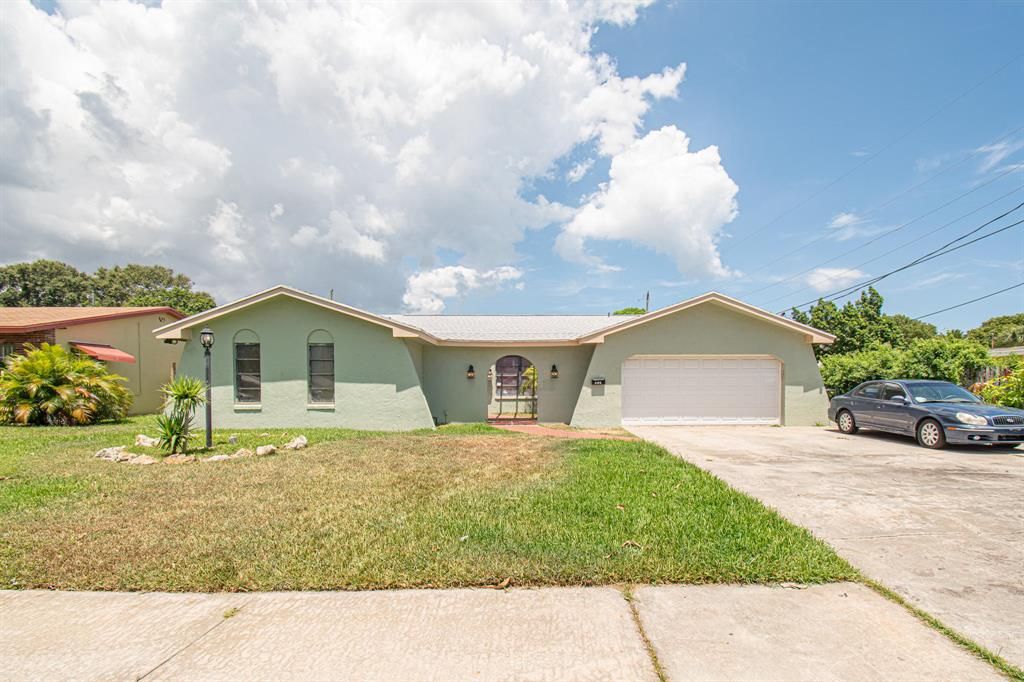 Photo of 211 Hawthorne Drive, Lake Park, FL 33403 (MLS # R10647174)