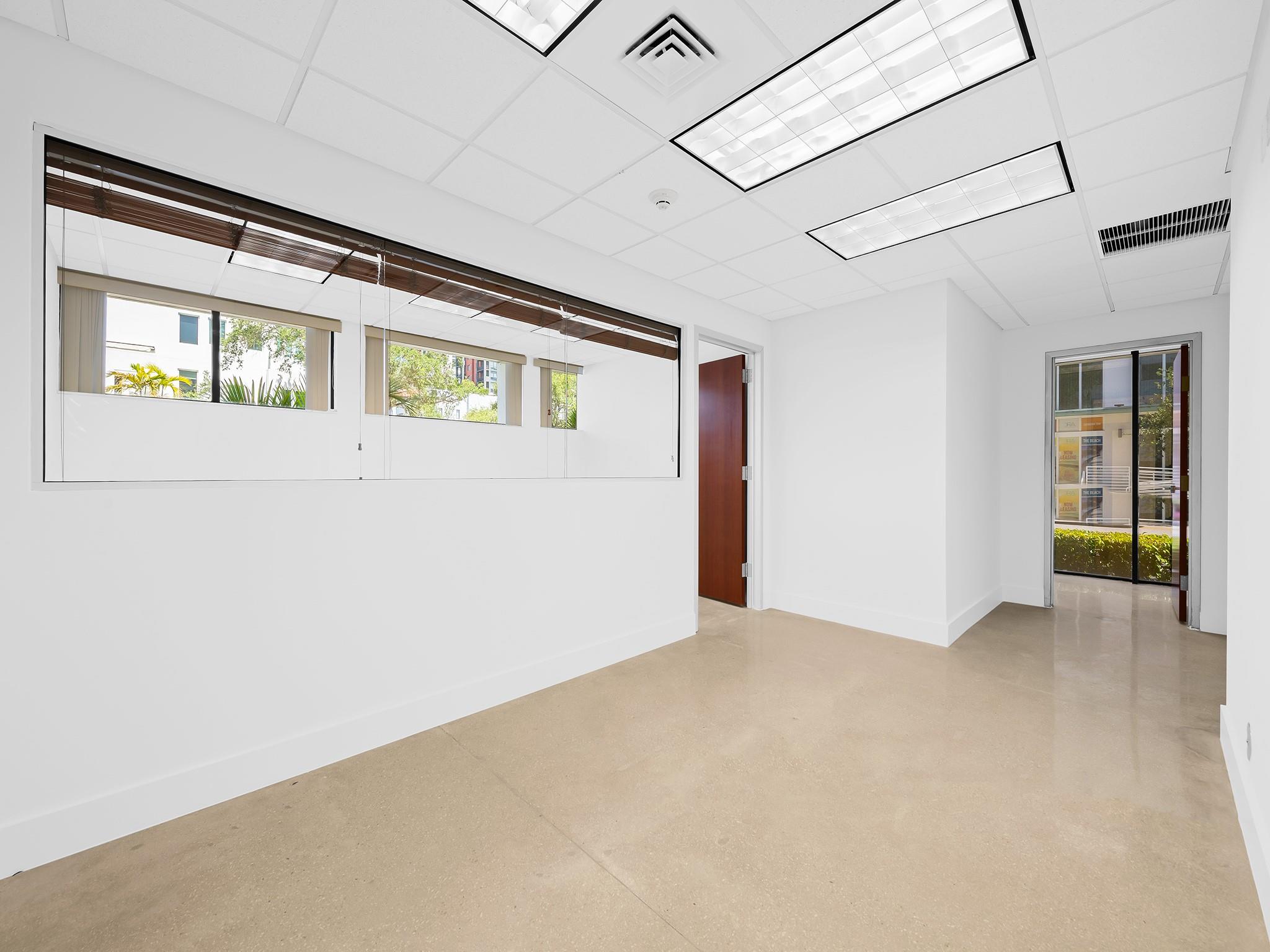 This contemporary office building located in Flagler Village offers an unique opportunity to secure a space designed with creativity and functionality in mind. This turn-key office space for lease is just a short distance from Downtown Fort Lauderdale and the lively Las Olas district in close proximity to major highways, including I-95 and I-595.
With the added benefit of onsite parking and large windows that allow for plenty of natural light, the environment is both functional and inviting. Its location near key business hubs, transportation options, and educational institutions makes it a practical choice for those looking to attract qualified talent and support.