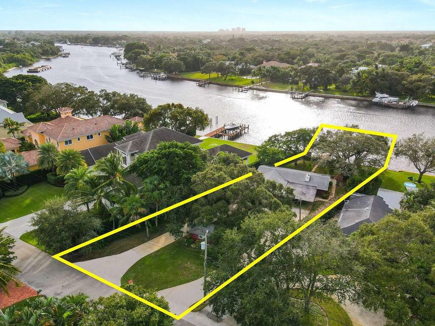 Oversized Intracoastal lot with dock, ideal for building a waterfront estate and living the ultimate Florida lifestyle of which dreams are made. Conveniently located on the Palm Beach Intracoastal Waterway with views of the boats going by. A 50' dock is included with a 5' water depth. Rarely available amount of waterfront land with plenty of mature trees and greenery, great for entertaining all of your outdoor activities and providing shade and ambiance. Perfect for boaters with access to deep water and no fixed bridges. Currently occupied with a charming 3 bedroom bungalow that could be a residence until building commences.