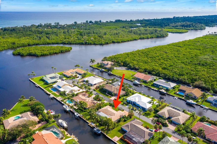Ocean Breezes and Intracoastal Views!  Watch sunrise with your morning coffee from your spacious patio. Keep your boat at your private dock with 10,000 lb lift. Four lots from Intracoastal with 110' of canal frontage.  Spacious 3 bedroom, 2-1/2 bath home has been updated and meticulously maintained.  The spacious master suite offers dual sinks, separate tub and shower and two walk-in closets.  One of the two guest rooms also opens to the patio and has views of the Intracoastal. Wide Chicago Brick driveway and walkways. Canal was recently dredged.  The Soundings features clubhouse, pool, tennis and pickle ball courts, RV and boat storage, boat ramp and dog park (coming soon).  Private water and sewer billed monthly through the Soundings.