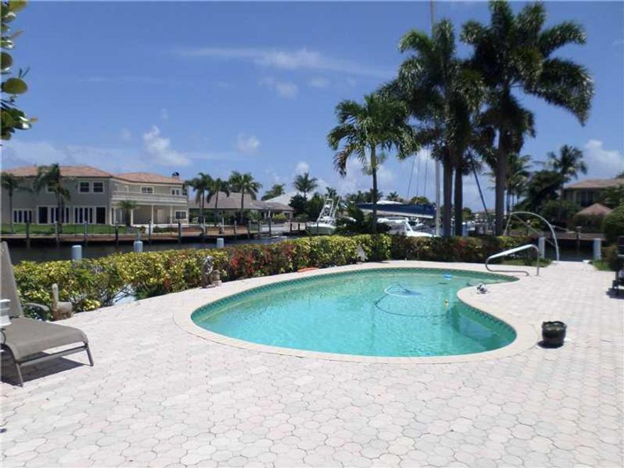 Fantastic NE Point Lot on the Kingfisher Canal with intersecting canals. 246 feet on the water. Covered patio for entertaining. Pool, two side yards. This home is 3 bedrooms, 2 1/2 bath with family room off kitchen. Update to your liking or build your dre am home!