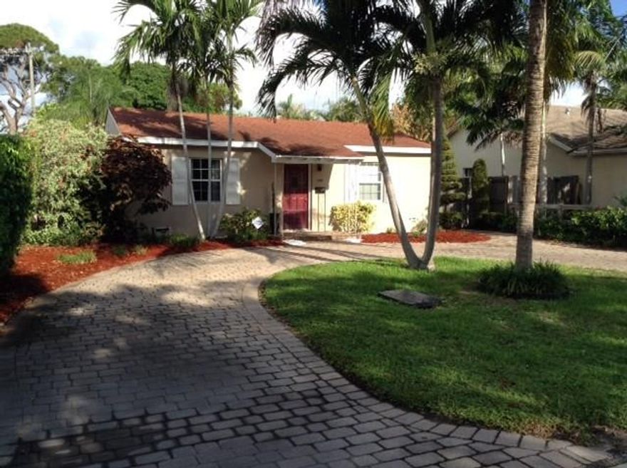 Charming 2/1 with tile flooring throughout.  Move in condition.  House features an open kitchen with newer appliances, spacious bath, alarm system, crown moldings in dining room and living room.   Fully fenced large yard with room for a pool.  Storage shed.   Roof approx 8 years old.  Hurricane shutters. Utility room with washer/dryer.   Brick paver patio and large paver circular driveway.  Pride of ownership shows in this house, your buyer will love it!     Convenient to shopping and not far to beach.