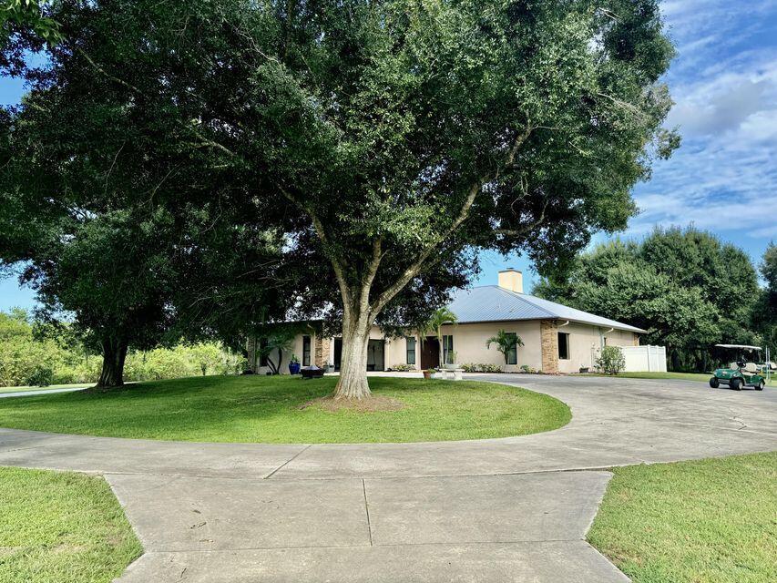 RIVER OAK ACRES - 7.83 Acres! Pool Home nestled in this serene and captivating property. This expansive estate features a 45 x 70 metal building with three metal doors and housing a one-bedroom Guest suite. The CBS home has 2200 ft under air and 5258 TLA. Upon entering the home, it opens to a grand foyer leading into a spacious living area, complete with a cozy fireplace. The enclosed Florida room provides a perfect space for year-round relaxation. The updated kitchen features bead board cabinetry, two pantrys with pull out shelves and a picturesque view. The home has both a formal dining room and bkfast area. The spacious master suite offers a walk-in closet w/ safe. The beautifully remodeled 4 x 5 roll in shower, double vanity and linen closet add to its grace.