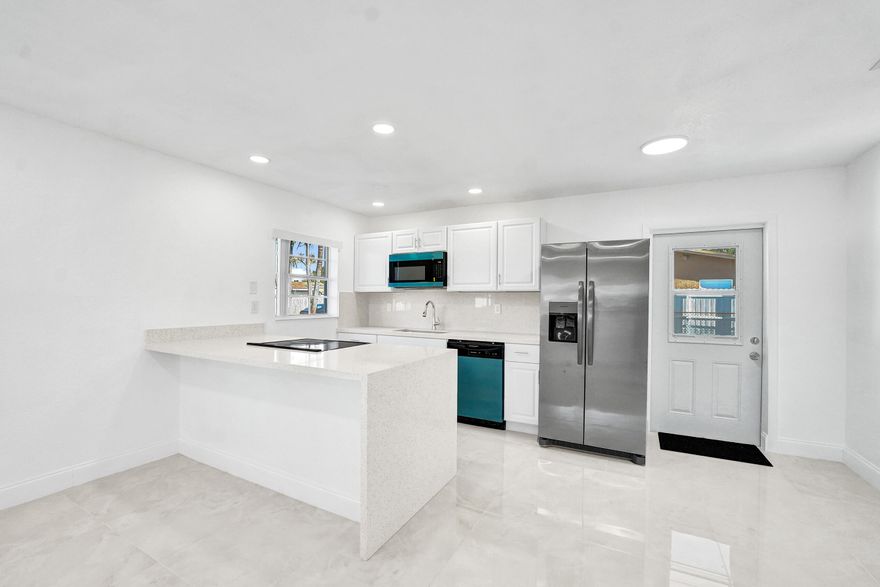 Fully renovated 3-bed, 1-bath home in Miami Gardens ready to impress! Enjoy a brand-new kitchen with quartz waterfall island, new cabinets, and new appliances. The updated bath features a sleek vanity and modern surround. New porcelain tile and luxury vinyl flooring flow throughout. A dedicated laundry/storage room adds function, plus a newer roof, new A/C, new hot water heater, and new electrical panel for peace of mind. Step outside to a large fenced yard with space for a pool, outdoor kitchen, RV, or boat. No HOA or restrictions! Minutes to Hard Rock Stadium, Hard Rock Casino, Miami Airport, shopping, dining, and major highways—live connected and carefree!