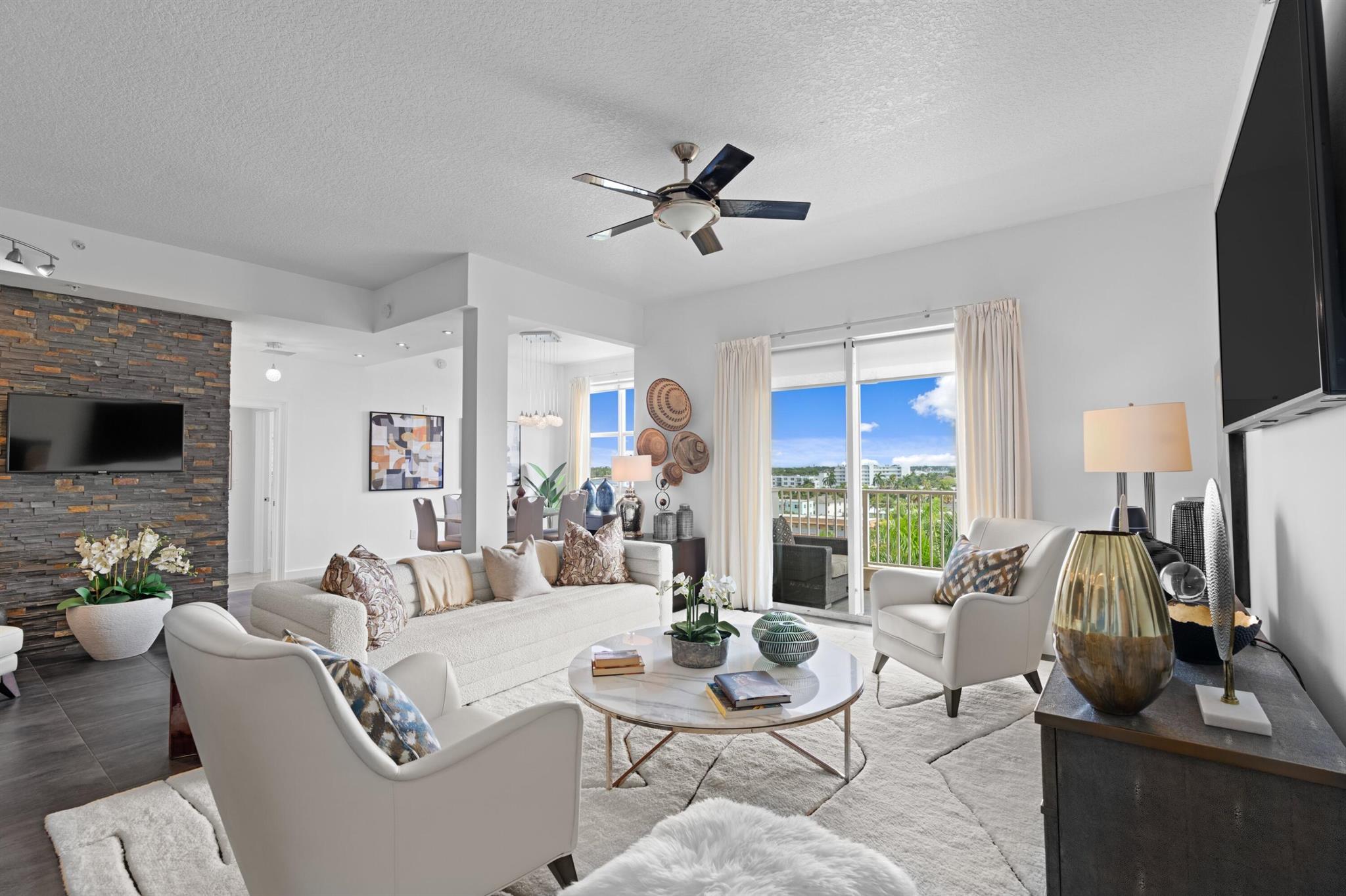 This fully renovated South-facing penthouse offers sweeping views of the Intracoastal Waterway. Originally a 3-bedroom layout, it has been reconfigured into a spacious 2-bedroom with a 150 sq. ft. terrace, creating exceptional indoor and outdoor living areas. Upgrades include porcelain tile flooring, natural stone accent walls, updated lighting, doors, hardware, and high-end kitchen and bathroom finishes. All appliances, countertops, and cabinetry have been replaced, with a newer AC and on-demand water heater. The primary suite features a custom walk-in closet. All windows and doors are hurricane-impact rated. Amenities include secure indoor parking, valet service, 24-hour staffed security, a marina and boat club, elevator access to two pools, and convenient garage-level access.