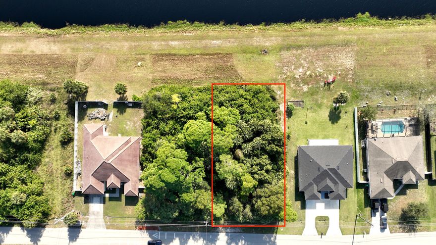 WATERFRONT LOT! Build your dream home on the C-24 Canal with access to freshwater boating and fishing. Approval can be filed for a private dock. This prime location is a commuter's dream, located minutes from I-95 and the Florida Turnpike, with fast access to dining and shopping. Don't miss this rear opportunity own a canal-front property with an amazing view and exceptional convenience.