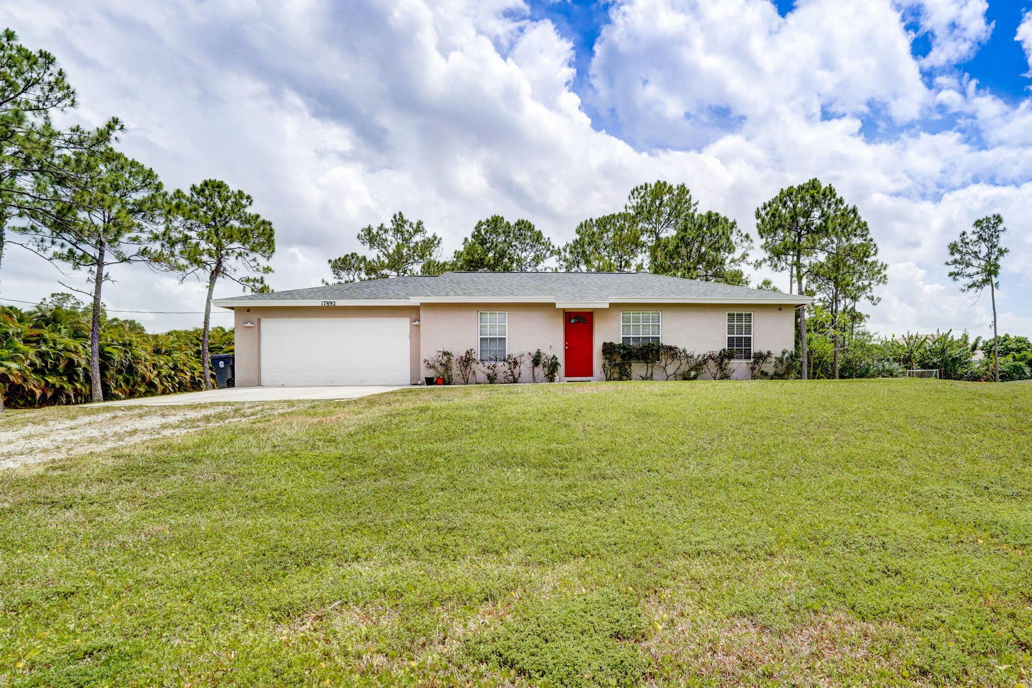Nestled on 1.2 acres, this 3-bed, 2-bath sanctuary includes a 2-car garage, a paved road, and public water, well for lawn. Inside, discover a move-in ready gem with a split floor plan, a cozy galley kitchen featuring a breakfast nook, and a delightful screened-in patio. Ample storage options include a convenient carport and sheds.