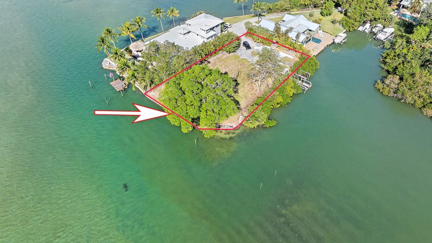 A rare opportunity to own one of Jupiter's most iconic waterfront lots! Positioned at the point of 50 E Riverside Dr, this 0.35-acre property offers 250+ ft of wide-water frontage with 180° views of the Loxahatchee River and private cove. Enjoy both sunrise and sunset views, a 30' dock with two lifts, and minutes-by-boat access to Jupiter Inlet. Survey Available and County- and State-approved seawall plans included. Mostly cleared and ready to build your dream home—an unmatched setting for luxurious waterfront living.