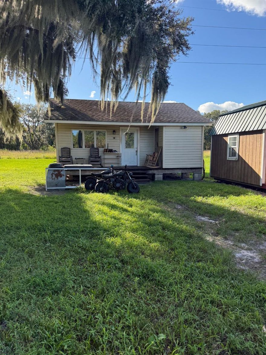 This is a beautiful piece of property, high and dry with many possibilities. It is 12.45 Acres in total. Quiet peaceful and private. Farm on it or just live in serenity away from the hussle and bussle. Close to everything, 20 minutes from Palm City or Okeechobee., 25 minutes from Jupiter and West Palm on Bee Line. Property includes a one bed, one bath Cottage, 54' x 60' metal building on concrete, dog pens and an additional 2 bedroom separate building.