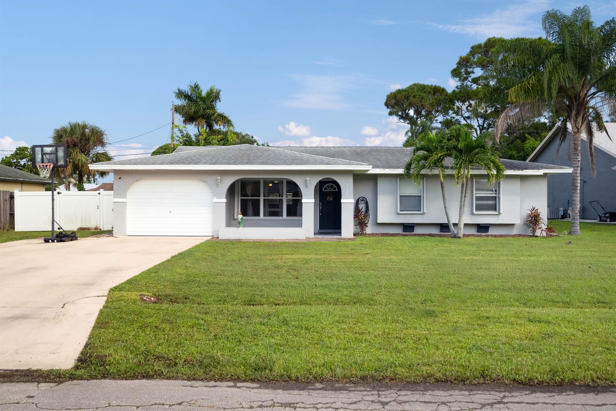 Charming CBS home with private fenced backyard, 3 Bedrooms, 2 Bathrooms home with one car garage. Granite bathrooms, and kitchen w/Stainless Steel appliances, extended driveway. No HOA so toys are welcome! Window seat, walk-in shower. Newer hot water heater, newer A/C, less than 4 years. Comfortable living space, 14 x 22 spacious enclosed Florida room. Great bones and perfect for a small family. This home is conveniently located approx. 20 minutes to Jensen Beach. Close to schools, shopping, highways, boat ramp, parks, dining, golf, theater, botanical gardens, community events. Great family home whether it's your first home, upgrading, or downsizing. Advanced notice requested, owner occupied, relocating, and motivated. Some handyman work needed. Perfect for a small family,
