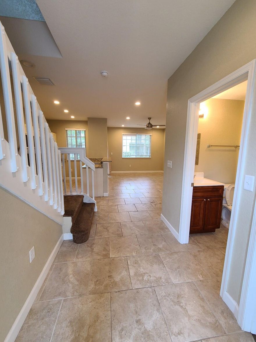 Completely renovated 3-bedroom, 3-bath townhouse featuring tile flooring in the living areas and laminate flooring in all bedrooms. Each bedroom has its own full bathroom. Spacious layout with one bedroom downstairs and two bedrooms upstairs. The unit includes new stainless steel appliances and an in-unit washer and dryer. Located in a 24-hour guard-gated community offering resort-style amenities including a pool, spa, clubhouse, fitness center, tennis courts, playgrounds, and scenic lake walking paths. Just 10 minutes from the beach and close to shopping, dining, and major highways. Investor-friendly community with the ability to rent immediately from day one, making it a great option for both homeowners and investors.