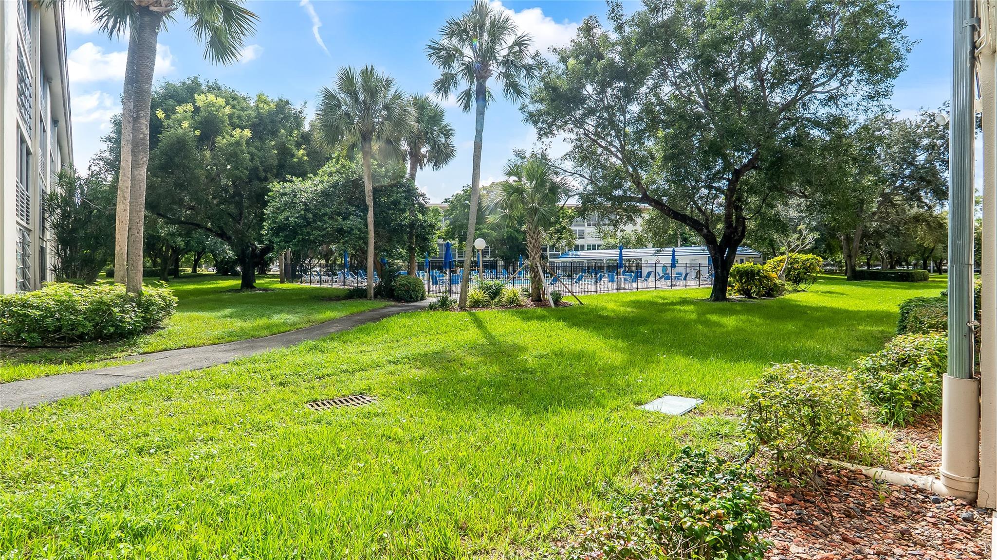Beautifully Renovated 1st-Floor Corner Condo by the Pool in Wynmoor Country Club! Enjoy resort-style living in this spacious and bright corner unit, perfectly located just steps from the pool! This desirable first-floor condo features a larger open layout with extra windows that fill the home with natural light. The modern kitchen boasts stainless steel appliances, granite countertops, and custom cabinetry, opening to a generous living area and screened patio—ideal for relaxing or entertaining with direct pool access. Located in the highly sought-after 55+ Wynmoor Country Club, residents enjoy unmatched amenities including golf, tennis, fitness center, theater, restaurant, multiple pools, courtesy buses, and 24-hour security. Move-in ready desirable corner unit steps from the pool!
