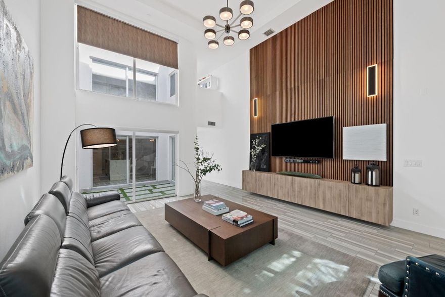 Modern, fully renovated Victoria Park townhouse tucked away on a private cul-de-sac. This spacious residence lives like a single-family home, offering three oversized bedroom suites plus a powder room. The chef’s kitchen showcases a waterfall island and Viking appliances, while soaring 20-foot ceilings and a striking indoor atrium flood the home with natural light. A New Roof, New AC's, Impact Windows and a two-car garage provide comfort and peace of mind. The third floor features an extra-large suite with a wet bar and private terrace, ideal for relaxing or entertaining. Perfectly positioned in a highly walkable neighborhood just 1.5 miles from the beach and downtown Fort Lauderdale. Move-in ready with every detail already taken care of.