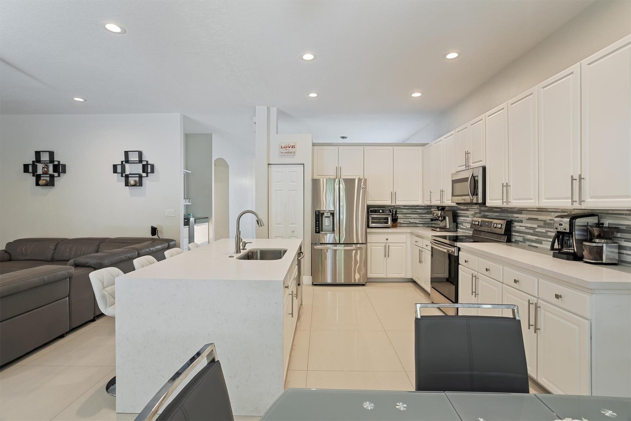 Experience the best of Weston living in the prestigious gated community of Isles at Weston! This elegant one-story home boasts soaring 14’ ceilings, a bright open layout, and a stunning chef’s kitchen with a large island and premium appliances. Step outside to a private backyard with a covered patio, ideal for relaxing or entertaining. Enjoy resort-style amenities: two pools, gym, spa, clubhouse, playgrounds, and more. Walk to top-rated A+ schools in a safe, family-friendly setting. Roof recently re-certified and transferable to buyers. Don’t miss this incredible opportunity, schedule your visit today! Whether you're raising a family or looking for a peaceful retreat, this home offers the perfect balance of comfort, luxury, and convenience.