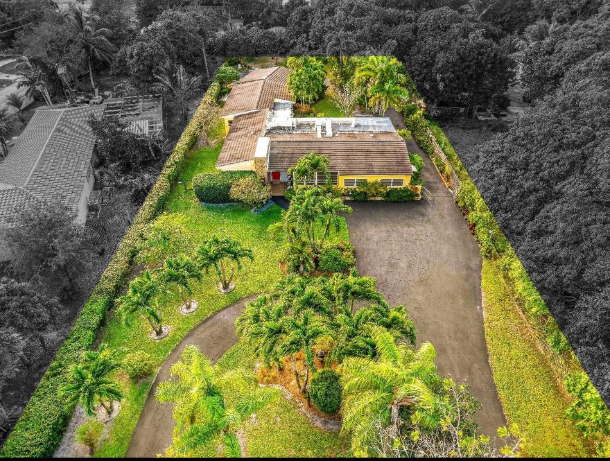 Discover a rare opportunity to own a 5-bedroom, 4-bath single-story home in desirable Biscayne Gardens. This gem is situated on an expansive 30,000+ sq. ft. lot with lush landscaping and mature fruit trees, this impressive residence offers approximately 3,901 sq. ft. of living space filled with abundant natural lighting classic terrazzo flooring. The roof was replaced in 2020, providing added peace of mind. Enjoy the inviting sunroom featuring beautiful wood-beam ceilings. The property also includes two private units, ideal for in-laws quarters or rental income. A unique offering with exceptional flexibility and outstanding potential.