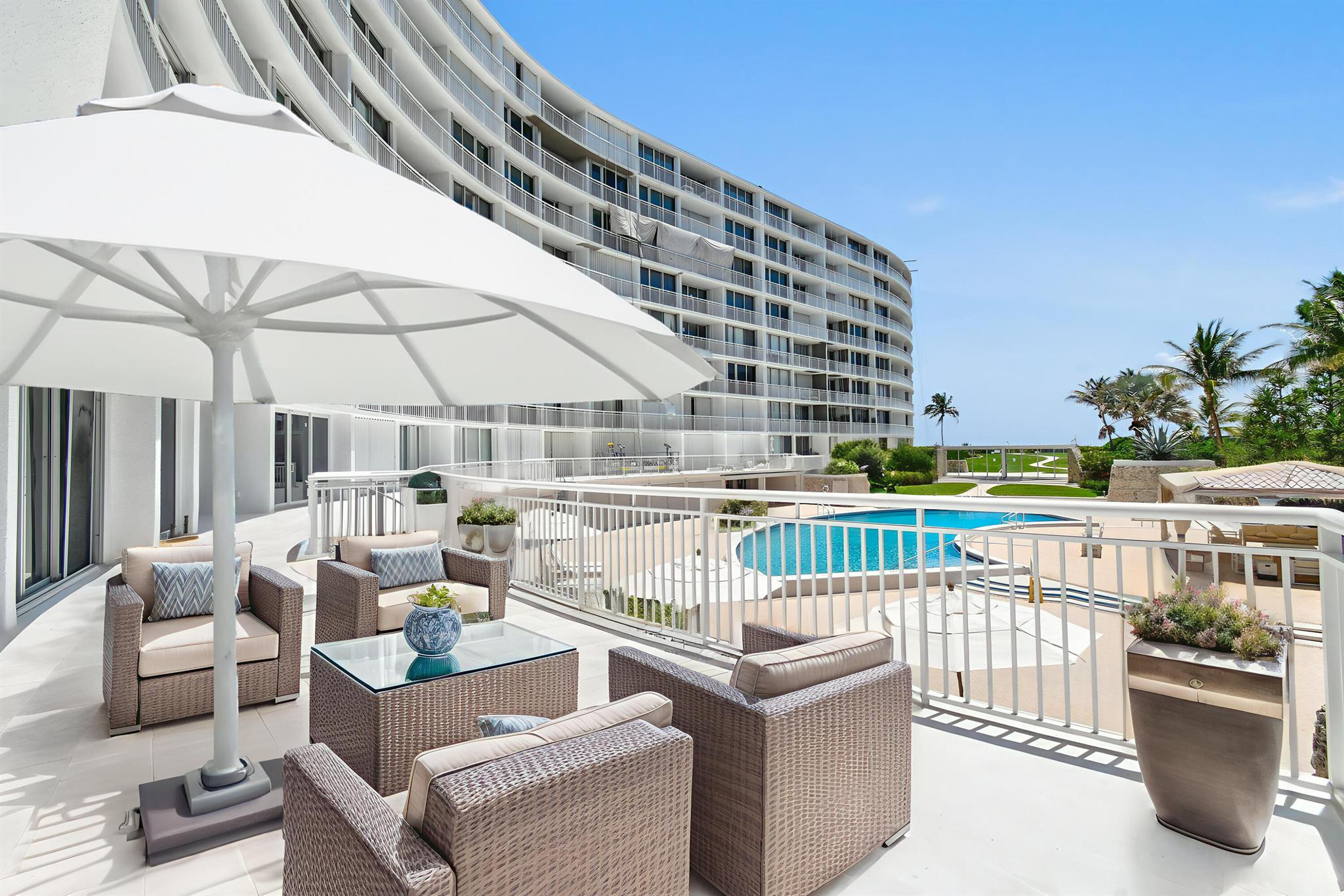 This exquisite east-facing lanai apartment offers two bedrooms and two baths with a spacious open floor plan, seamlessly blending indoor comfort with outdoor beauty. Enjoy direct access to the pool and beach, and take in panoramic views from the expansive 400 sq. ft. terrace--perfect for entertaining or relaxing under the palms. Private stairs from the terrace lead straight to the pool and the sea beyond, offering an unmatched indoor-outdoor lifestyle. Wake up to breathtaking sunrises in this light-filled residence framed by lush landscaped gardens and the serene blues of the Atlantic. Furniture negotiable.