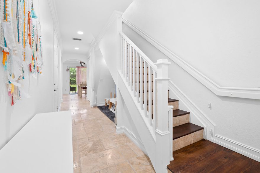 Bright and spacious 2-story townhome in prime East Delray, just minutes to Atlantic Ave and the beach. Features include 9' ceilings, crown molding, tumbled marble floors, and an open layout with a flex nook ideal for a bar or office. Kitchen offers granite countertops, stainless steel appliances, marble backsplash, and ample cabinetry. Upstairs bedrooms feature wood floors and walk-in closets. Primary suite includes dual sinks, soaking tub, and separate shower. Enjoy ocean breezes on your private patio. Impact windows, 2018 A/C, and 2021 water heater. Pet-friendly community with pool, playground, fitness center, and sidewalks, conveniently located near shopping, dining, and downtown Delray.