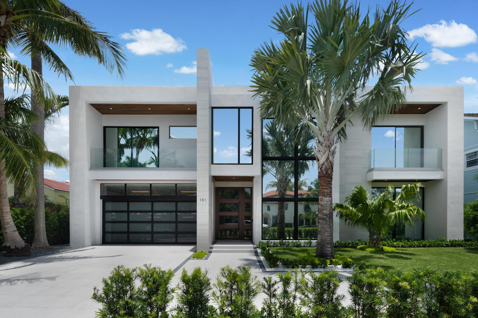 Experience cutting-edge design and comfort at 141 Cortez Rd. in W.P.B.'s prestigious SoSo area, near the Intracoastal. This 6,774 sq. ft. home epitomizes modern luxury, offering sophistication and ease. Highlights include a grand entry foyer with a magnificent staircase, a state-of-the-art media room, and a chef's kitchen with high-end appliances and wood-accented ceilings. The stylish dining area provides pool views. The living room features a fireplace and wet bar, perfect for entertaining. The attached guest house includes a kitchenette and private balcony. The owner's suite boasts dual baths and a balcony overlooking the pool. Enjoy the rooftop deck with stunning views. Additional features include a luxurious elevator, Control4 automation, laundry on both floors, and a 60 kW generator