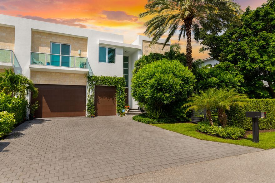 Yes, you can have it all. Location, modern architectural masterpiece, square footage, 5 bedrooms, 5 bathrooms with a tropical serene backyard paradise. 
This boutique, one of two, townhomes lives like a single-family home located in the highly sought-after Seagate neighborhood - Walkability score 100! Located just two blocks from the beach, one block to the Intracoastal, & a short walk to restaurants, night life, and art galleries on  Atlantic Avenue, ''The Ave'' all while being on a beautiful, quiet street. You will find soaring ceilings throughout this modern home, floor to ceiling impact windows & doors, reinforced concrete frame & roof, and a whole house, natural gas generator. The chef's kitchen features  Miele appliances, custom Italian Casa Mia cabinetry, & custom lighting. The massive primary suite features a sitting area overlooking a beautiful garden oasis, including His and Her custom walk-in closets and primary bath with large soaking tub as well as separate His and Her wash stations.  Additional Features Include:

*Lutron motor shades and custom window treatments
*Porcelanosa wood-like tile 
*Custom walk-in closets throughout
*New gas burning fireplace
*Interior and Exterior camera system
*Smart Home Controls
*Tropical landscaping, including a large grassed yard
*Stunning Alex Turco patio wall mural
*Recently refinished heated pool and jacuzzi
*New patio pavers and landscape lighting
*Elevator
*Custom Sound and Camera System