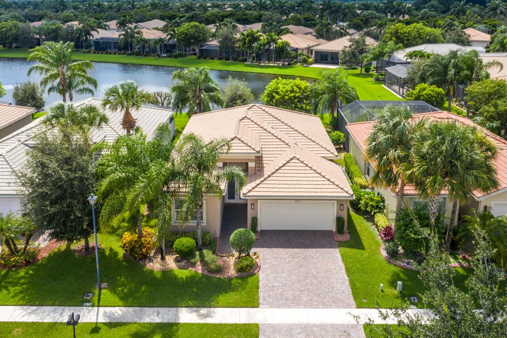 BRING YOUR MOST DISCERNING BUYER TO THIS ONE OF A KIND AND BEAUTIFULLY FURNISHED HOME WITH OVER $160,000 IN UPGRADES. YOU'LL LOVE THE IMPACT ETCHED GLASS ENTRY WITH PHANTOM SCREEN, STUNNING PORCELAIN FLOORS IN LIVING AREAS AND BEAUTIFUL WOOD FLOORS IN BEDROOMS. ENJOY YOUR AIR-CONDITIONED FLORIDA ROOM WITH IMPACT GLASS WALL-TO-WALL SLIDERS. RELAX ON YOUR LARGE PATIO IN A PARKLIKE SETTING OVERLOOKING A SERENE LAKE VIEW. A DESIGNER KITCHEN OFFERS WHITE SHAKER CABINETS, UPGRADED STAINLESS STEEL APPLIANCES, CONTEMPORARY BACKSPLASH, AND IMPRESSIVE GRANITE COUNTERTOPS. CUSTOM WALL UNITS IN DEN, GREAT ROOM AND FLORIDA ROOM. BEVELED MIRROR IN DINING ROOM AND DETAILED CROWN MOLDING THROUGHOUT. BEAUTIFUL LIGHTING, CEILING FANS, HIGH-HATS AND SO MUCH MORE! THIS MOVE-IN READY 5 STAR HOME IS FOR YOU!!!