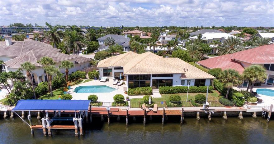Imagine a view of glimmering intracoastal waters, 137' wide and entirely unobstructed. Nestled at the edge of this cul-de-sac lies 3161 Jasmine Dr, in the most unique boat enthusiast neighborhood of Tropic Isle. This direct intracoastal, oversized lot fuses casual elegance with tropical charm. Entertain now with guests, or satisfy your creative side and inspire your dream home. Picturesque water transparency as soon as you walk through the front door and dances through every room. Boasting 4 bedrooms, 3 newer renovated bathrooms, an oversized laundry room, and a gourmet kitchen. The lush landscaping exudes privacy all around the heated pool and private dock. The canopy boat house (available to be covered) is one of the few left on the intracoastal (grandfathered in).