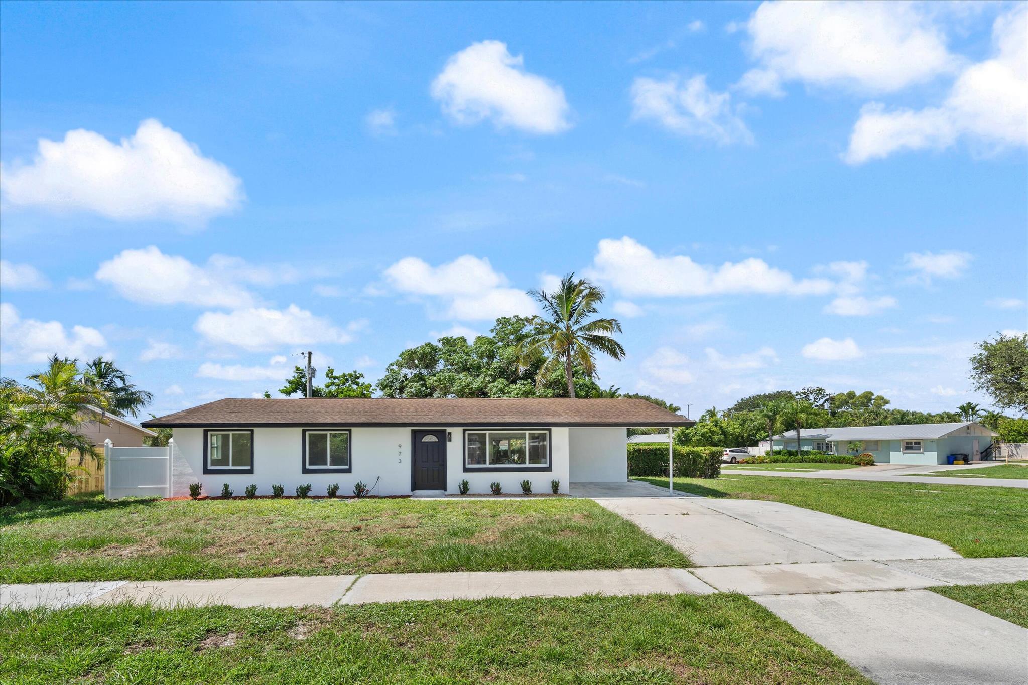 BRAND NEW INSIDE. Stunning remodel on this classic style home in the heart of North Palm Beach. 3-bedroom 2 bath concrete home with impact windows at 1100 sqft will make any stay comfortable. No HOA and close to everything, shops, restaurants, beaches, Florida at its best. This corner lot home on .23 acres has a large backyard and patio space. Can easily fit a pool and enjoy the sun year-round. Great space to become an investment property for an Airbnb or winter home for snowbirds. Measurements are approximate.