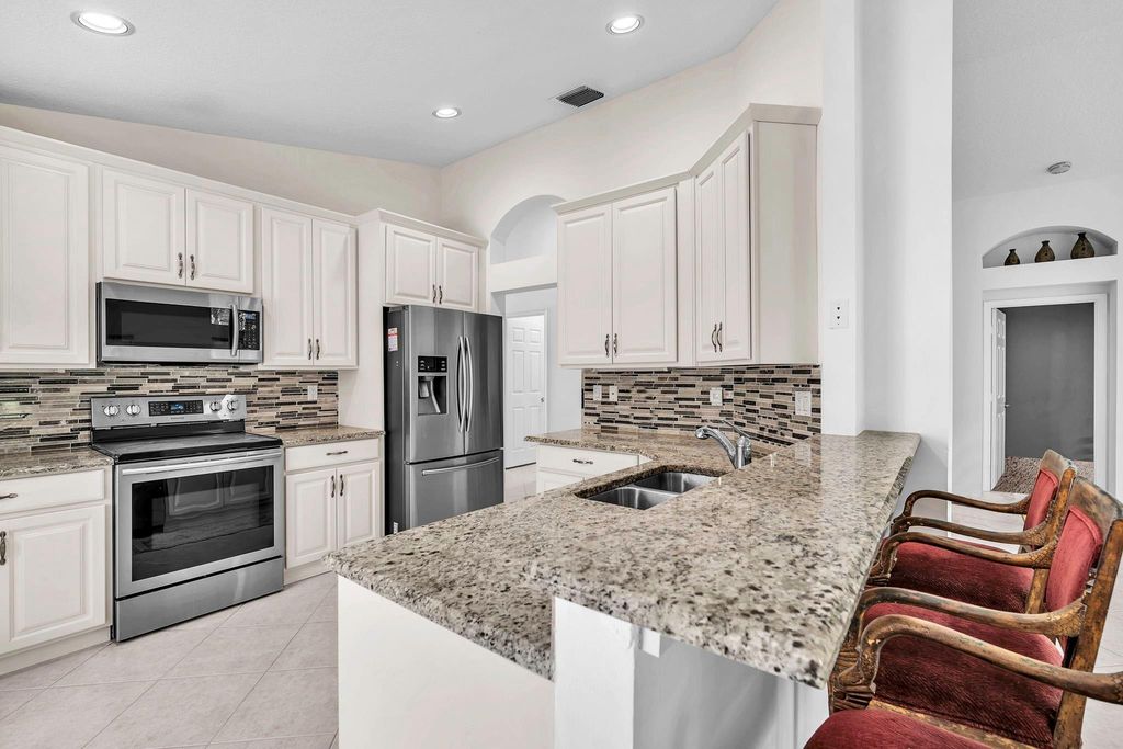 Photo of 5701 Swaying Palm Lane, Boynton Beach, FL 33437 (MLS # F10532041)