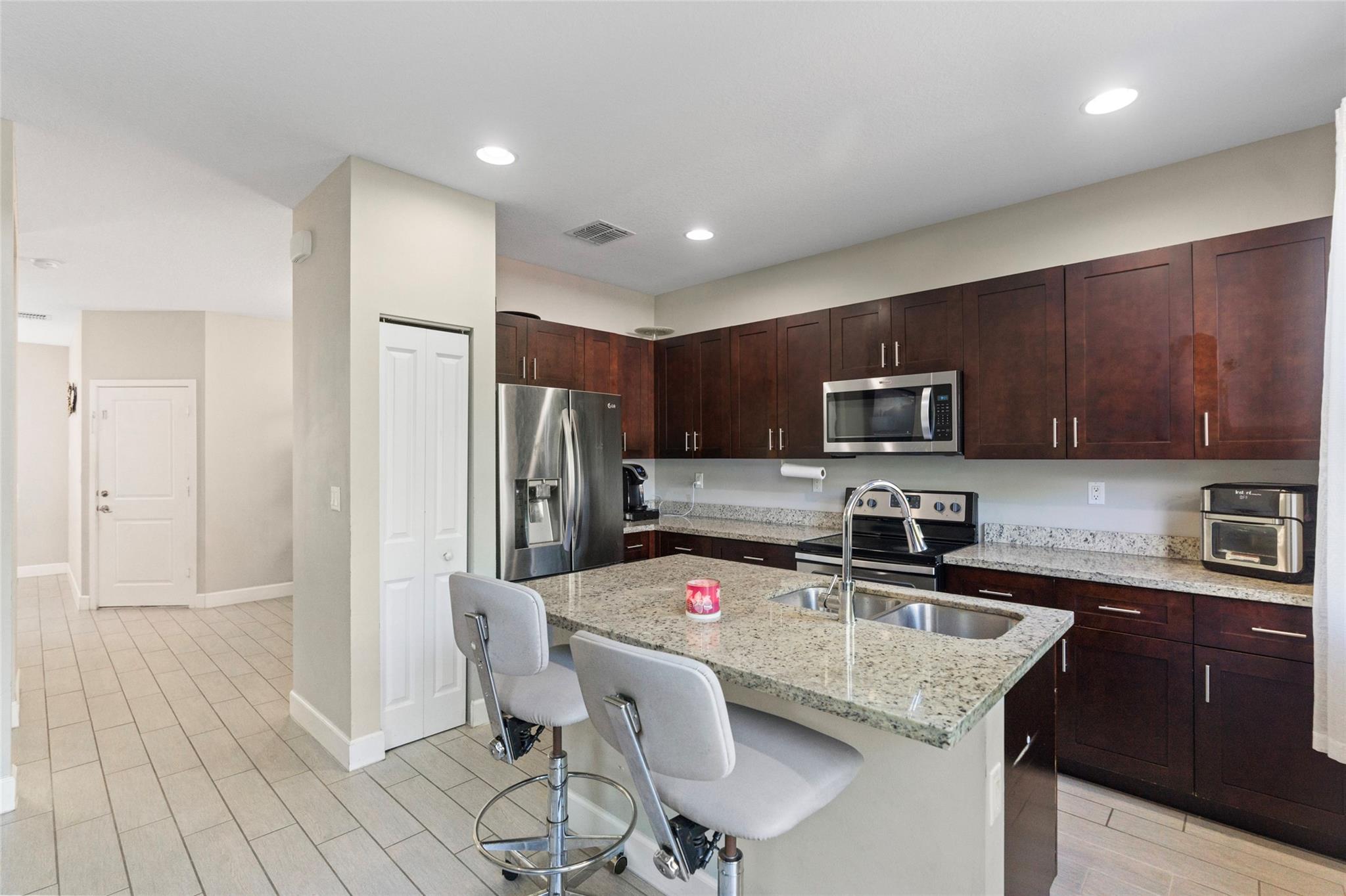 Modern 2019-built SINGLE-FAMILY in the sought-after Manor Parc! This 3-bed, 2.5-bath home features ALL PGT impact windows & doors, BRICK paver driveway, tile roof, and a covered front porch. The open layout includes a spacious formal living area, formal dining room AND GREAT ROOM. The modern kitchen includes 36" ESPRESSO SOLID WOOD cabinetry, with island, stainless steel appliances & OPEN to great room. Enjoy PEACEFUL living with no rear neighbors, nearby guest parking & on a PRIVATE street. Community amenities include RESORT STYLE pool, cabana with restrooms, BBQ area, playgrounds, and scenic walking paths. Prime location near Turnpike, I-95, Sawgrass Mills, dining, and beaches. No HOA approval required.