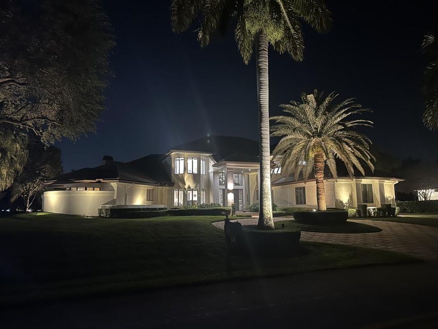 This magnificent 1.15-acre lakefront estate in Windmill Ranch Estates offers a lifestyle defined by soaring 22' ceilings, stunning living spaces, and gourmet kitchen. Floor plan features, main-level primary suite, office/flex space, guest room, second floor has 3 bedrooms and studio. Oversized covered patio with a summer kitchen, outdoor fireplace overlooks the oversized pool and lake. Updates include a 2018 roof, 2019; HVAC (4), and new appliances. Priced  incorporating no impact. Truly an amazing home