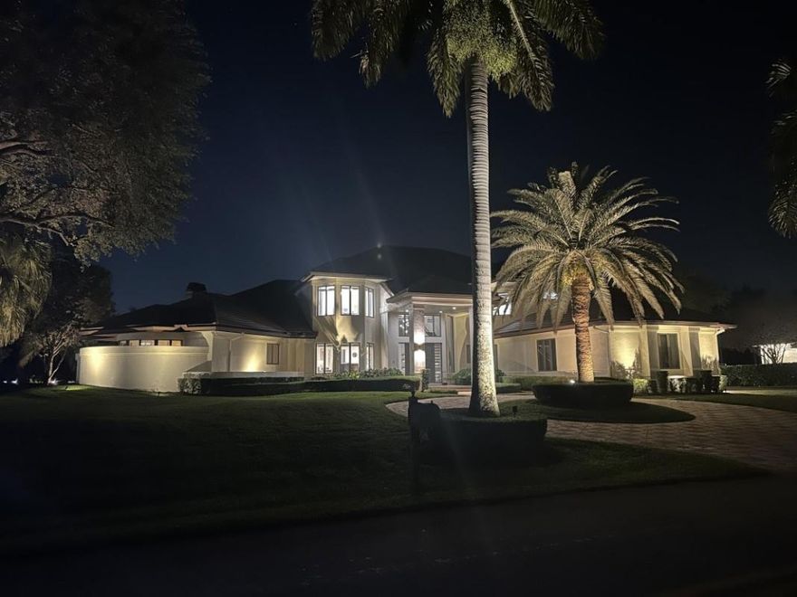 This magnificent 1.15-acre lakefront estate in Windmill Ranch Estates offers a lifestyle defined by soaring 22' ceilings, stunning living spaces, and gourmet kitchen. Floor plan features, main-level primary suite, office/flex space, guest room, second floor has 3 bedrooms and studio. Oversized covered patio with a summer kitchen, outdoor fireplace overlooks the oversized pool and lake. Updates include a 2018 roof, 2019; HVAC (4), and new appliances. Priced  incorporating no impact. Truly an amazing home