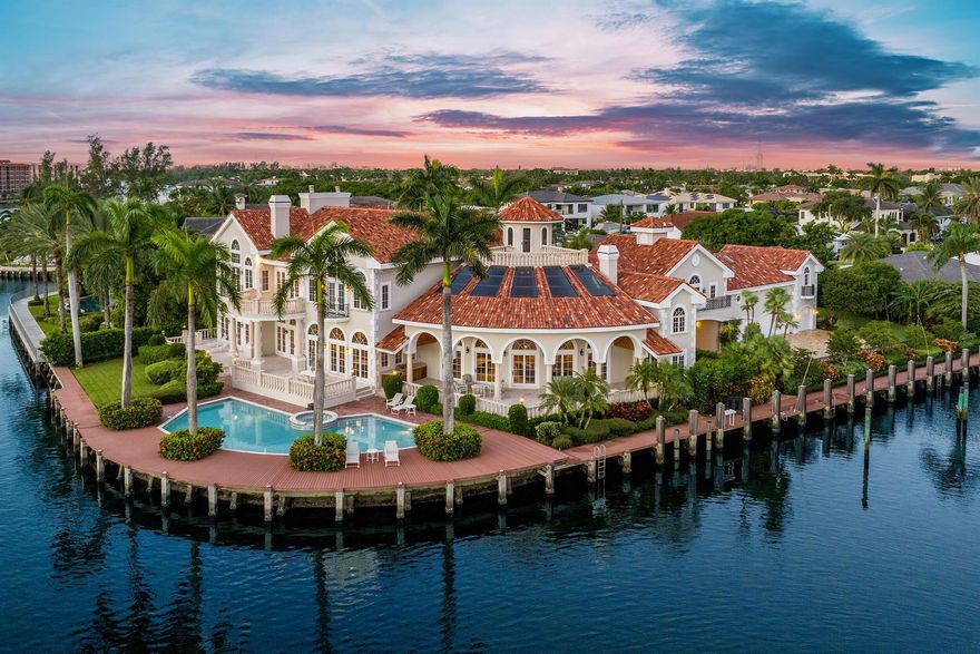 EXTRAORDINARY VALUE: PRICE REDUCED BY $1,245,000. Presenting Villa Bellevue, an elegant European-inspired waterfront estate that embodies timeless sophistication. Nestled within the revered confines of Lake Rogers Isle, offering serene and unobstructed views of Spanish River Park and Intracoastal Waterway, Villa Bellevue stands as a tribute to classical elegance, beckoning those with the most discerning of tastes.Step through the regal property gates and a world of refined beauty unfolds. This expansive 2.5-lot (0.74-acre) waterside estate boasts lofty 30'+/- soaring ceilings, robust concrete construction, a 5-car garage, and a total of 17,998+/- square feet, with approximately 12,340+/- square feet of interior living space.