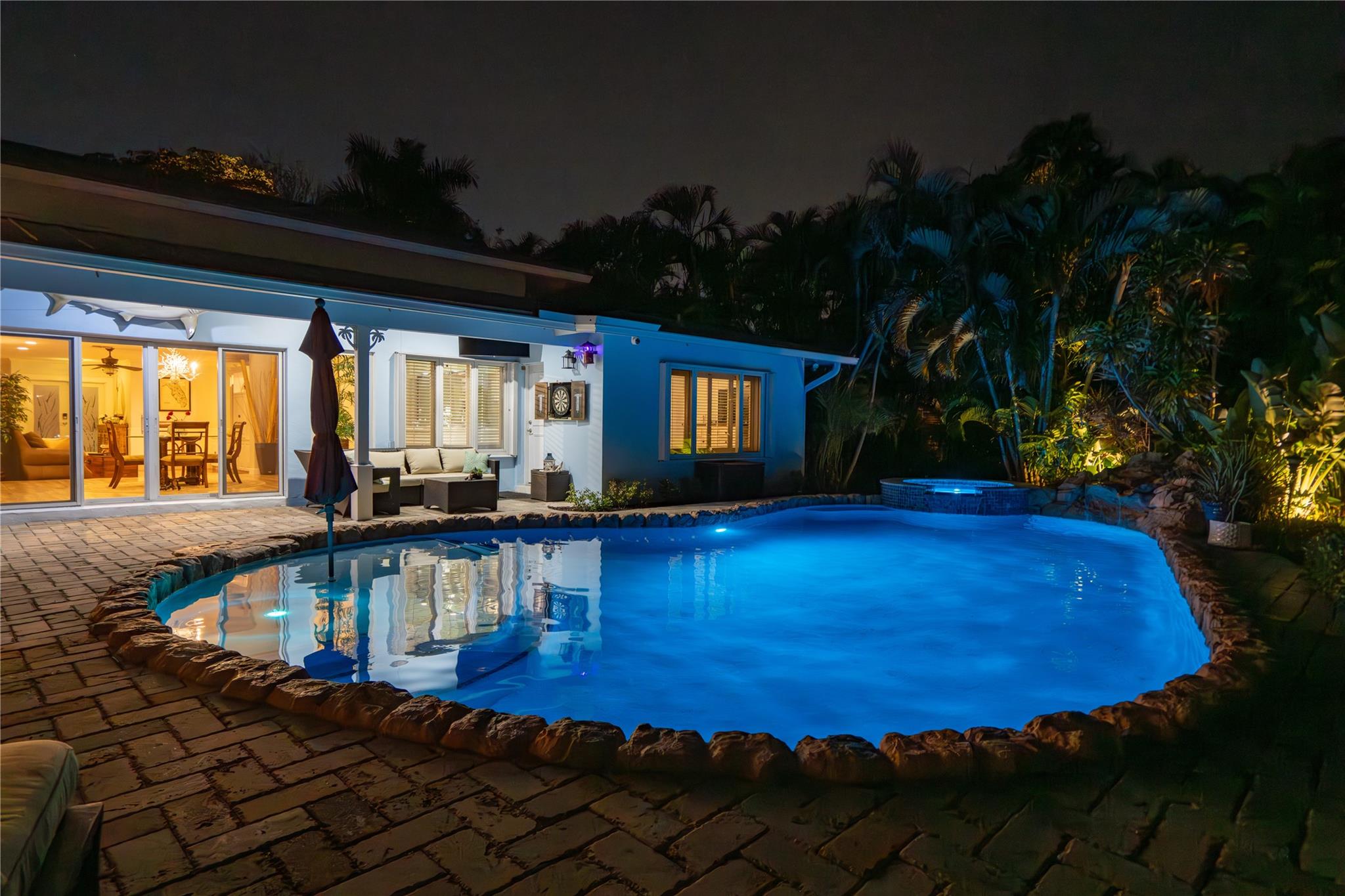 Endless sunrise water views straight down the closest canal to the Hillsboro Inlet! This coastal home in South Lighthouse Point with excellent curb appeal boasts 4 beds and 4 baths in a split bed floor plan with 2 primary suites and zoned air conditioning. The large kitchen opens to the family room in the heart of the home and both take in the amazing view. Formal Living and dining rooms. The additional dining area is perfect for every day dining looking down the canal. Huge primary bedrooms. When you step outside you will enjoy a tropical yard with remodeled heated pool/spa with salt chlorination, newer polymer dock, 16K lbs boat lift and access to the cabana bath. As you leave your dock in your boat you are less than 5 minutes to open ocean water!