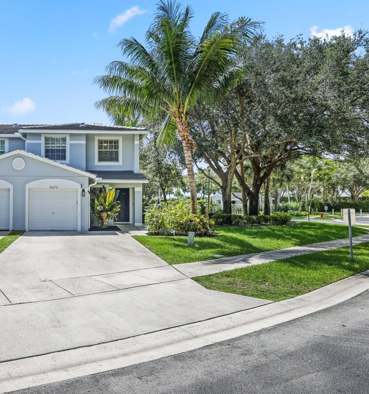 Welcome to this beautifully upgraded corner townhome in the gated Sierra Palms community of Delray Beach, featuring a brand-new 2025 roof. This 3-bedroom, 2.1-bathroom home blends comfort, modern upgrades, and family- friendly community amenities within the highly acclaimed Palm Beach County School District. Key enhancements include a renovated kitchen with a new island, updated cabinetry, and a dining seating area, as well as an updated first-floor half bath and a second-floor guest bathroom with a luxurious deep soaking tub. A cleverly designed under-stairs nook, perfect for a cozy book space, pet area, or extra storage, adds a unique touch. Enjoy Florida living on the expansive back patio, surrounded by tropical landscaping and serene lake views. The gated community boasts a newly