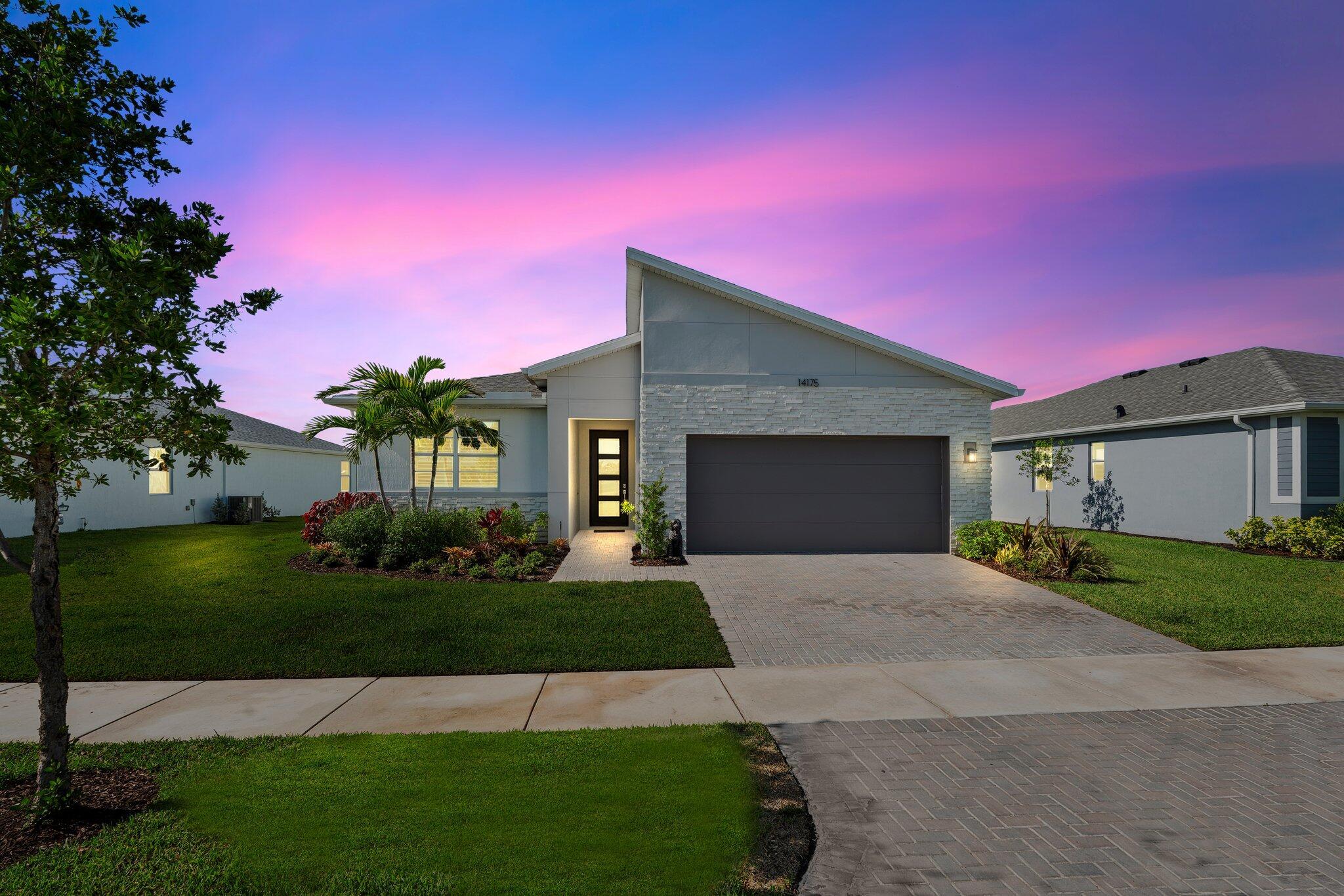 Newer home with upgrades galore! This stunning Gateway model sits on a premium lakefront lot and features an open floor plan with beautiful lake views. Enjoy wood plank tile, soaring ceilings, impact windows/doors, and upgraded fans and fixtures throughout. The gourmet kitchen shines with quartz counters, stainless appliances, gas stove, glass tile backsplash, and a large island. The split floor plan offers a private owner's suite and ample storage with pull-out drawers and a walk-in pantry. Relax on the extended, screened lanai surrounded by tropical landscaping and a yard with room for a pool (pool plan available upon request). Located in Cadence at Tradition with resort-style amenities, scenic trails, and close to shopping, dining, and community events.