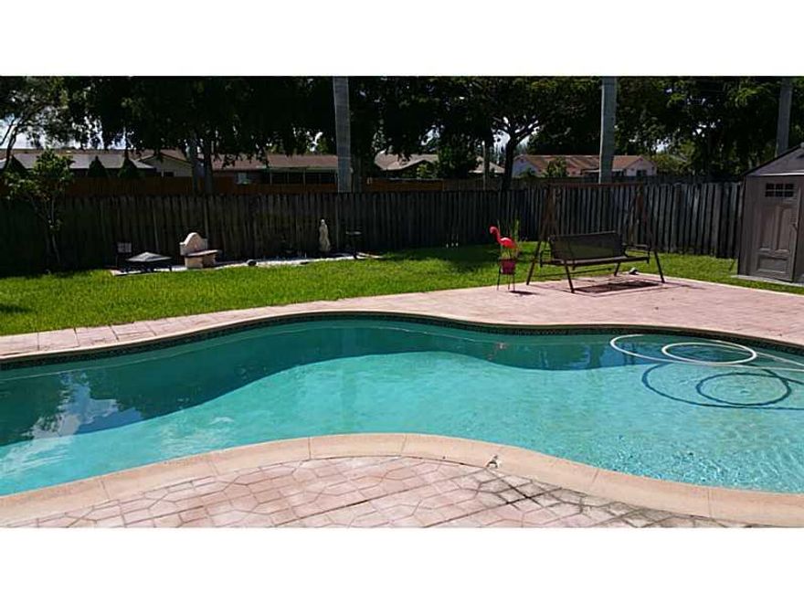 HURRICANE IMPACT WINDOWS THROUGHOUT, CERAMIC TILE IN MAIN AREAS AND KITCHEN, LAMINATE WOOD FLOORING IN ALL 3 BEDROOMS AND CLOSET. UPDATED BATHROOMS.  SHED CONVEYS WITH SALE. ROOF WAS TOTALLY REPLACED AFTER HURRICANE WILMA.  VERY LARGE BACKYARD WITH POOL A ND PRIVACY FENCE. AUTO SPRINKLER SYSTEM. QUIET STREET IN SOUGHT AFTER NEIGHBORHOOD.