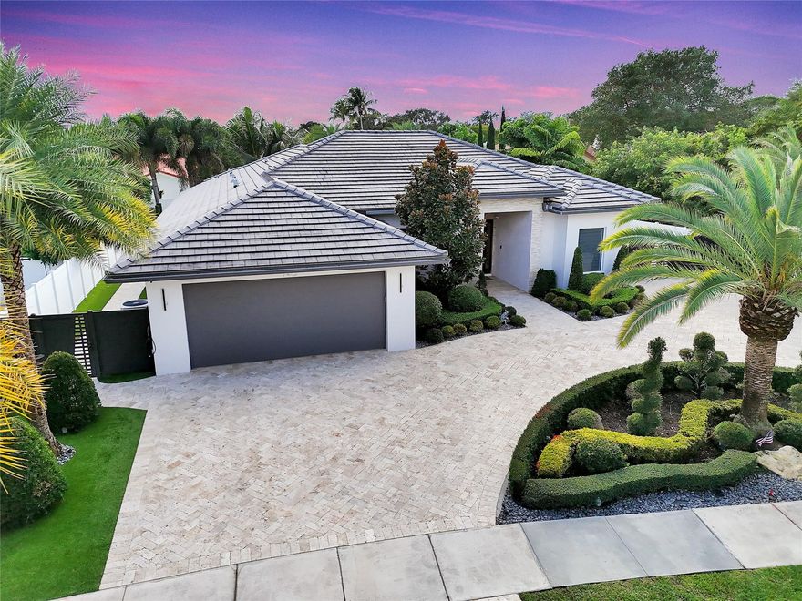 Discover unparalleled luxury in this custom-built residence, perfectly situated in East Boca Raton’s most desirable location. Meticulously crafted with premium upgrades—foam insulation, double-insulated walls, designer lighting, Sonos sound, and full security system. A chef’s kitchen showcases custom soft-close cabinetry, Crystallo stone surfaces, induction cooktop, KitchenAid appliances, and an elegant storage-rich island. The primary suite features a stunning Agatha stone accent wall and bespoke closets. Enjoy a resort-style outdoor oasis with a quartzite-clad summer kitchen, dual BBQs, travertine pavers, saltwater pool, custom shed, and PGT impact doors and windows. Experience luxury living in this custom-built residence, crafted with exceptional quality and thoughtful upgrades throughout. This immaculate home features full foam attic insulation, double-insulated exterior walls, flat ceilings with recessed lighting, a whole-home Sonos sound system, full camera surveillance, solid wood doors, and custom curtains.The designer kitchen offers custom soft-close cabinetry, Crystallo countertops with a porcelain slab backsplash, an induction cooktop, KitchenAid appliances, a wine cooler, exterior-vented exhaust fan, and an oversized island with storage on both sides.The primary suite impresses with a custom wood-panel feature wall accented by semi-precious Agatha stone, custom bathroom cabinetry, and fully built-out closets. The cabana bath is finished floor-to-ceiling in natural quartzite stone.Outdoor living is elevated with a fully equipped outdoor kitchen, including a striking avocado-green quartzite full-wall backsplash and two built-in barbecue styles. Enjoy travertine pavers, a saltwater pool, foam-insulated tongue-and-groove ceilings, custom landscaping, and a custom storage shed. Home is secured with PGT high-impact doors and windows.A rare opportunity to own a truly bespoke home with premium finishes and craftsmanship at every turn.