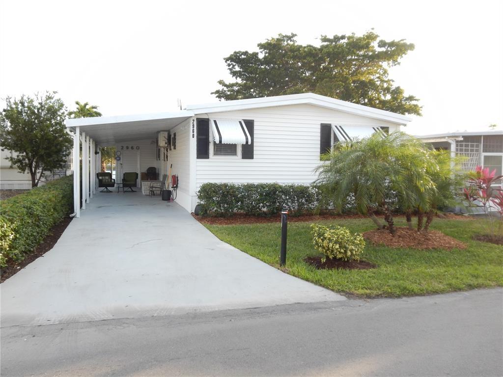 ***BREATHTAKING LAKEFRONT PROPERTY*** IMMACULATE 2 BED 2 BATH MANUFACTURED HOME LOCATED IN THE ESTATES OF FT LAUDERDALE. THIS HOME FEATURES: A NICE OPEN FLOOR PLAN. BEAUTIFULLY FURNISHED. GOURMET KITCHEN W/GRANITE, BACK SPLASH, SS APPLIANCES, COOKING ISLAND/SNACK COUNTER W/STOOLS. CUSTOM MADE DOORS & CLOSET DOORS. ALL SHEETROCK. GORGEOUS LIGHTING. DUCTLESS CENTRAL A/C. NEW ROOF & PLUMBING. HURRICANE-GLASS WINDOWS FLORIDA ROOM W/PANORAMIC VIEWS OF THE LAKE..!! LOUNGING AREA UNDER CARPORT. RELAX & GREAT FOR ENTERTAINING...!!! SCHEDULE YOUR PRIVATE VIEWING TODAY...!!!