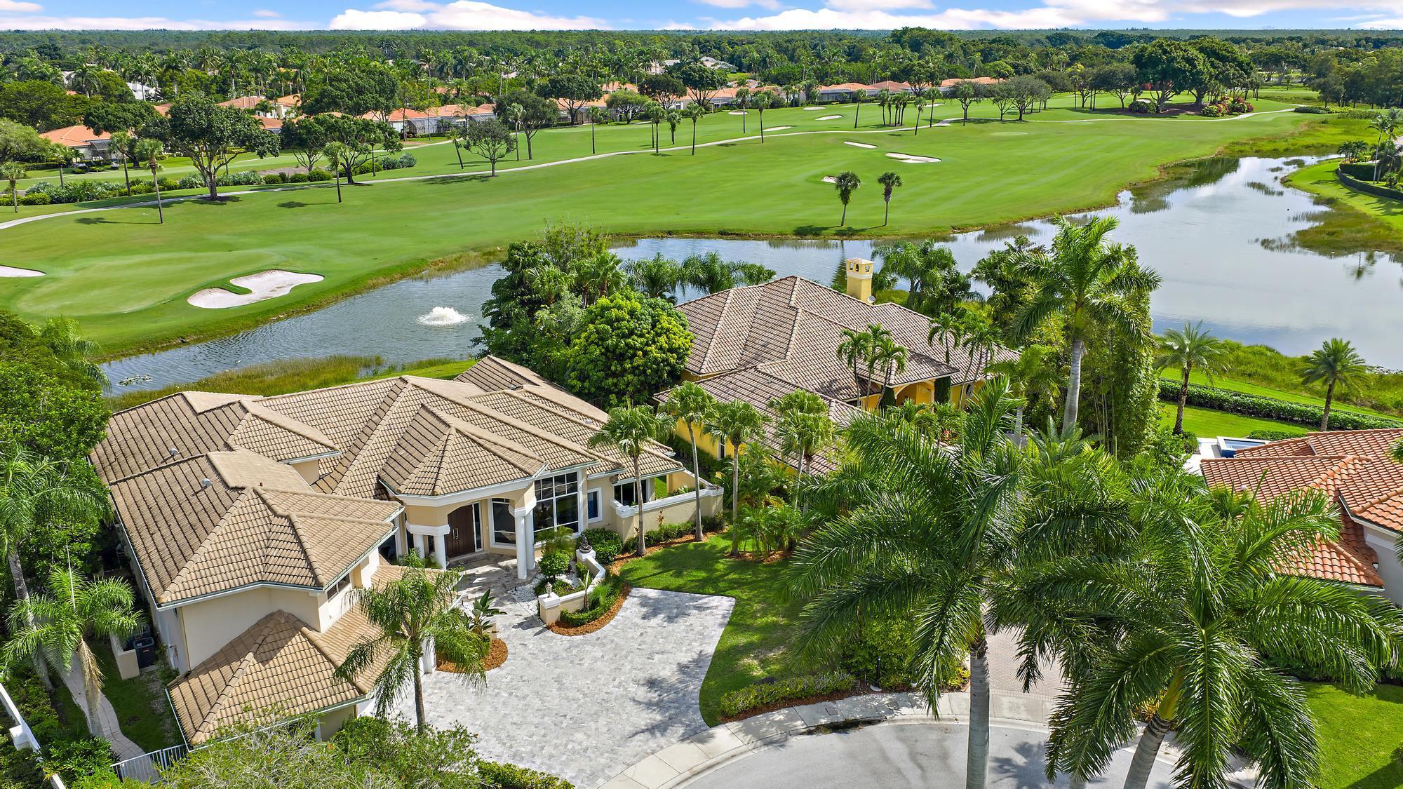 IMMEDIATE PREMIER GOLF MEMBERSHIP AVAILABLE. This expansive and elegant estate has been modernized and offers breathtaking views of water and the 6th green of the Jack Nicklaus-designed Legend Course. With 6BR/7.5BA, this impressive residence is situated on more than one-third of an acre in a private cul-de-sac, showcasing 120 feet of water frontage. The result is a perfect blend of scenic beauty and privacy--all within close proximity to the main Ibis gate, and Ibis's world-class amenities, for added convenience. The home has been transformed with sleek and stylish renovations, many of which done in 2021. Chic porcelain tile flows throughout the main living areas, complementing the soaring ceilings and expansive open spaces.