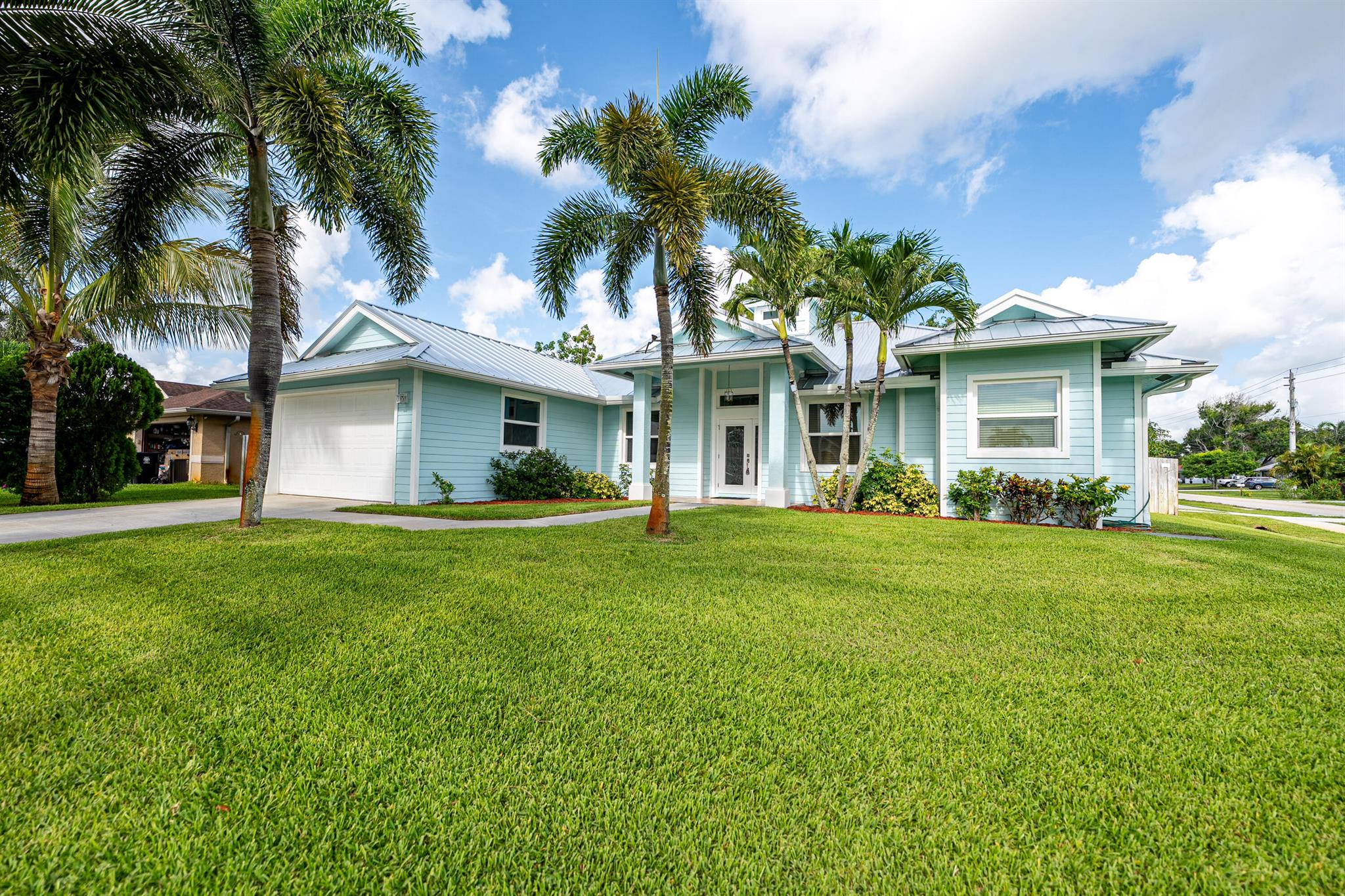 Tropical Key West-Style Pool Home with New Upgrades! This 3 bed, 2 bath home with a 2-car garage + office/den (optional 4th bedroom) sits on an oversized, fenced corner lot with lush landscaping and a saltwater pool. Featuring a new metal roof (2024), impact windows (2022), new A/C system (2024), and a whole-house generator (recently serviced) powered by an in-ground propane tank. Includes a R/V or boat parking area on the side of the property! Vaulted ceilings, granite countertops, upgraded cabinets, and tray ceilings elevate the open floor plan. Enjoy a spacious master suite with backyard access, a screened-in patio, fruit trees, and a garden. Convenient to I-95, top schools, shopping, and dining! Don't miss this move-in ready gem!