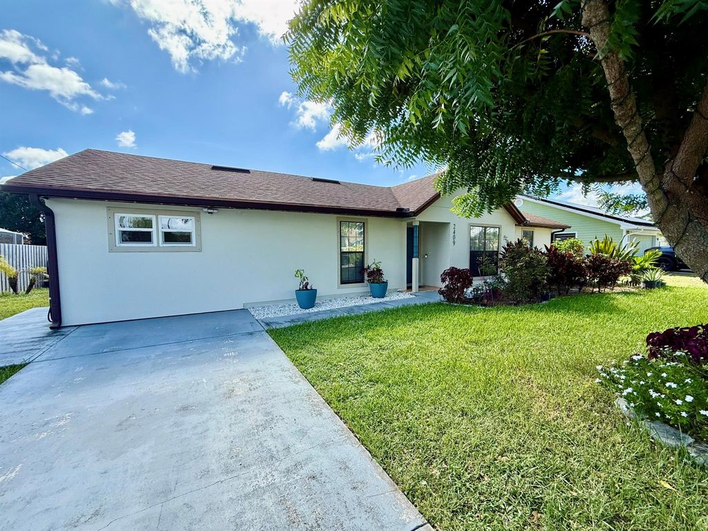 Photo of 2409 SW Hinchman Street, Port Saint Lucie, FL 34984 (MLS # R11119972)