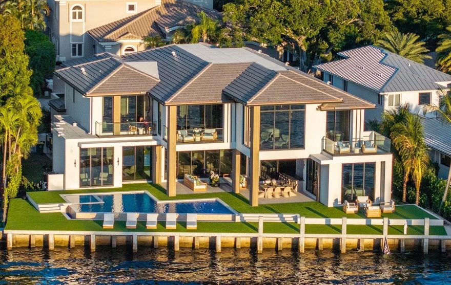 This NEW construction Intracoastal estate completed June 1, 2025 in prestigious Sea Ranch Lakes is a masterpiece of ultra-luxe design. Residents of this exclusive, gated community have peace of mind in this police protected Village. 9,200 total sq ft, all the newest technology, integrating indoor/outdoor living w/sliding glass walls, east/west light filled views and intracoastal breezes.  This turnkey home with 110’ of waterfront features elegant millwork, 300 bottle wine display, infinity pool, generous sized bedrooms and bathrooms. Primary bedroom features separate bathrooms & luxurious walk-in closets. Additional features include elevator, clubroom, 3-car garage, boat dock, generator ready & lush landscaping, private Beach Club. Located minutes from prestigious Pine Crest School.